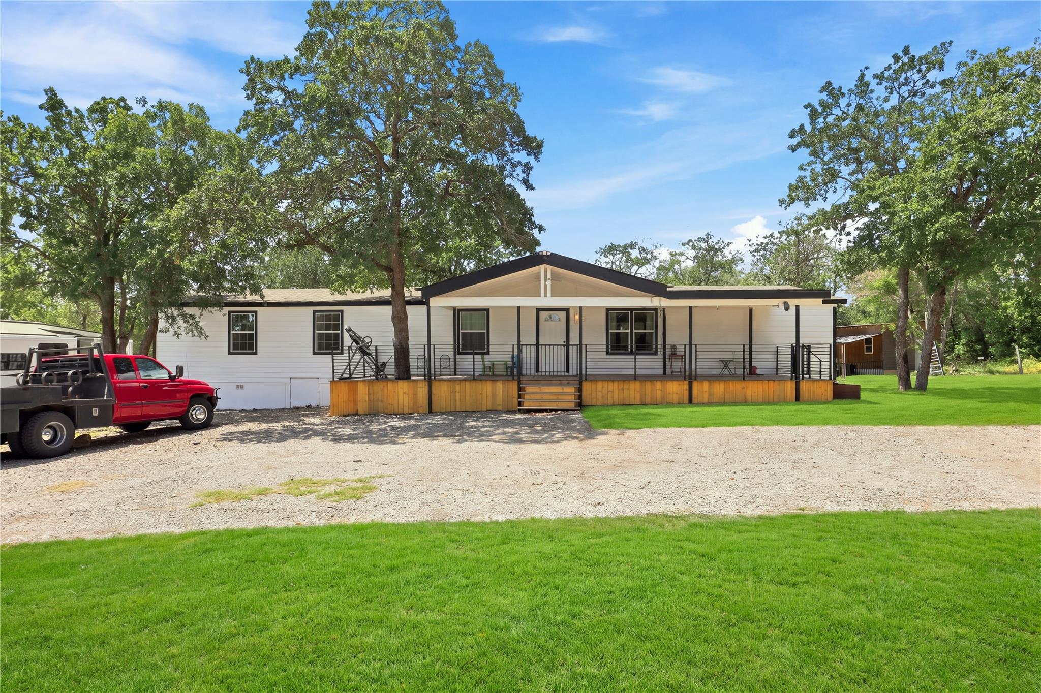 Mature shade trees and a welcoming front porch fr