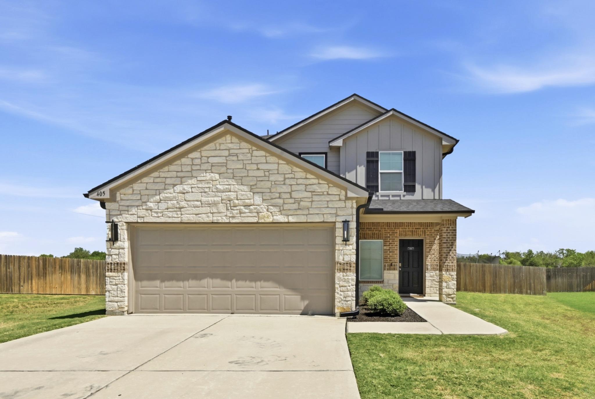 Natural stone accents and classic vertical siding