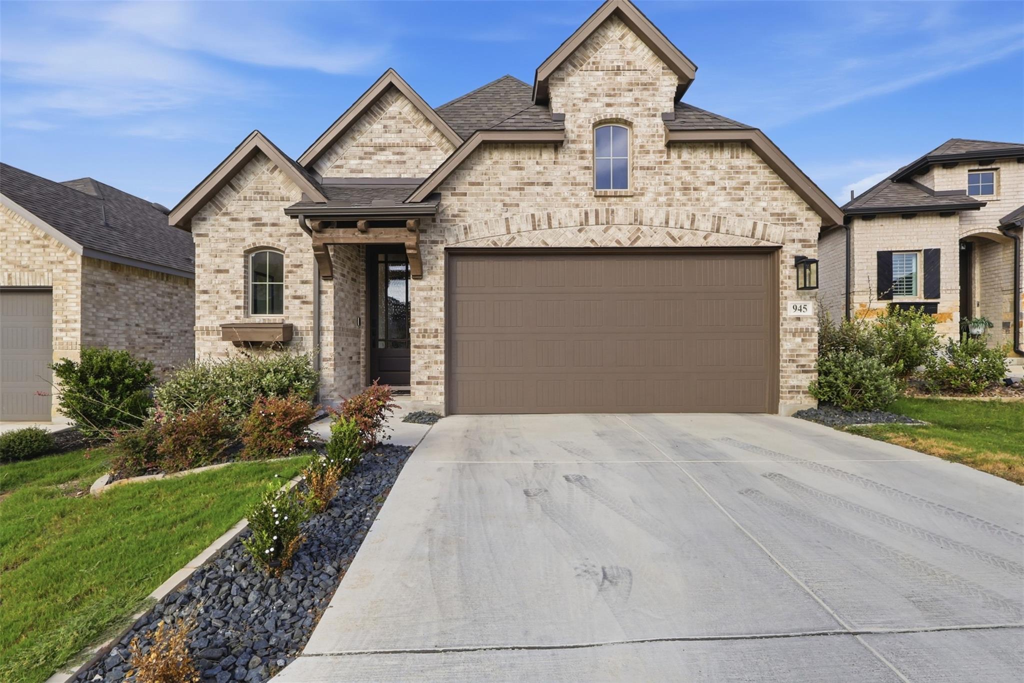 Multi-textured brick masonry and a concrete drive