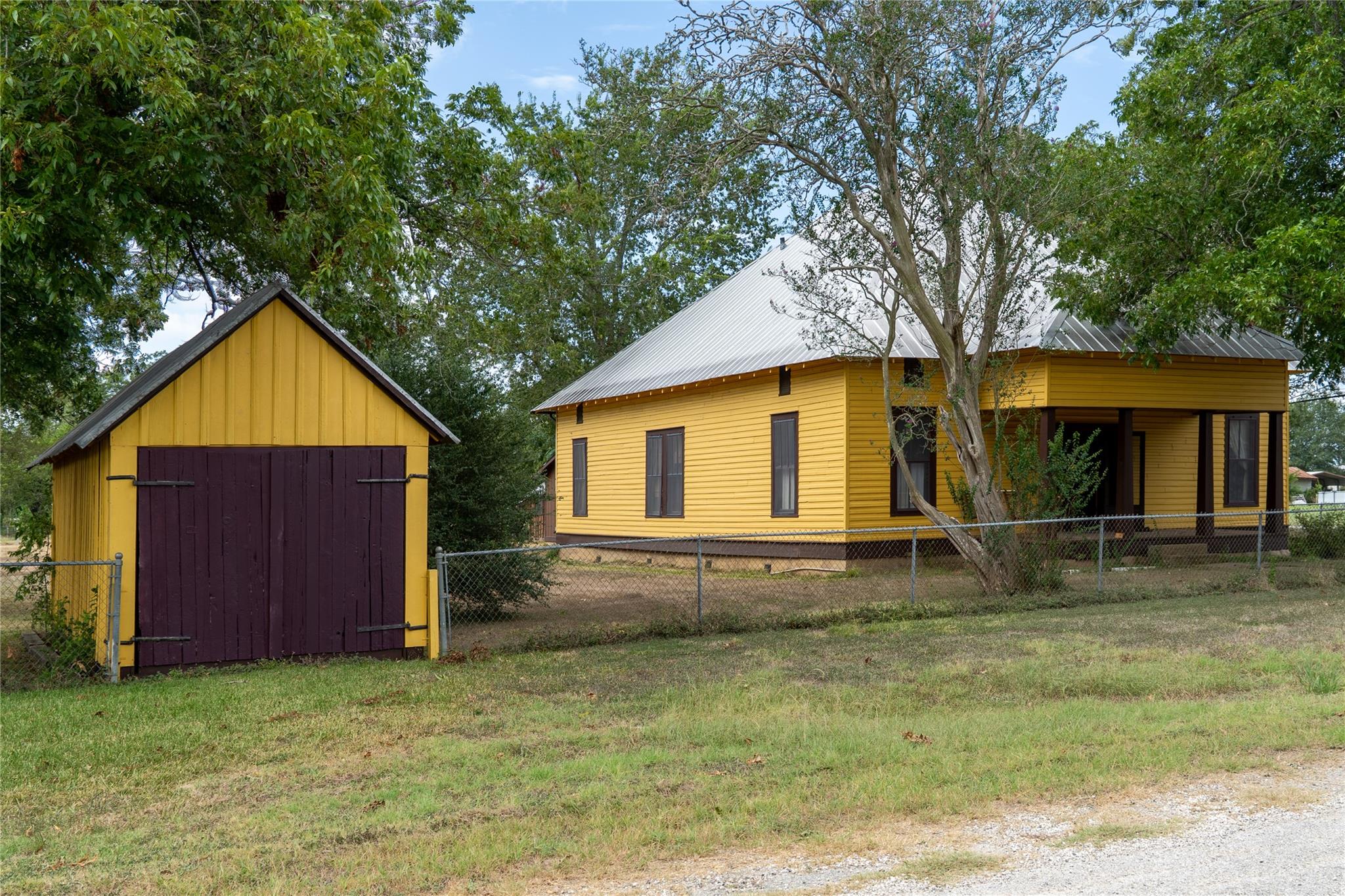 Mature trees shade a historic-style home paired w