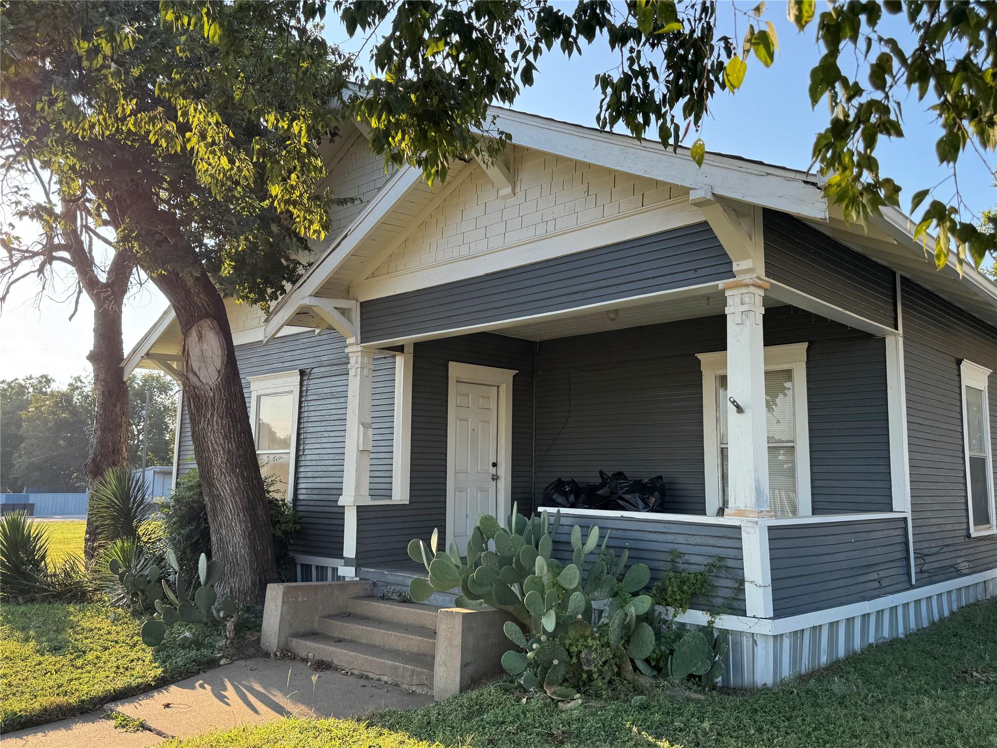 A welcoming front porch with classic columns anch