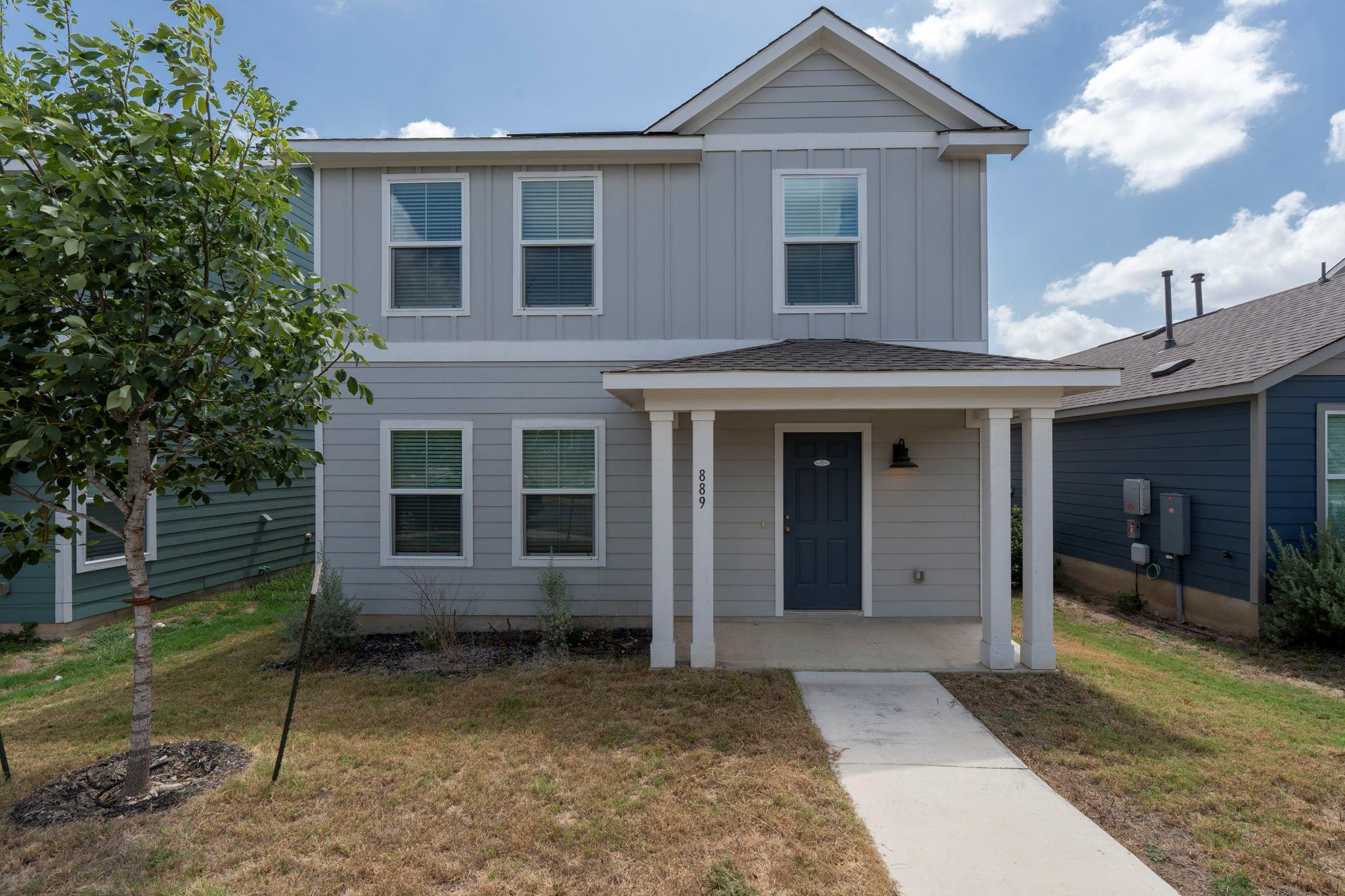 A welcoming front porch and crisp siding define t