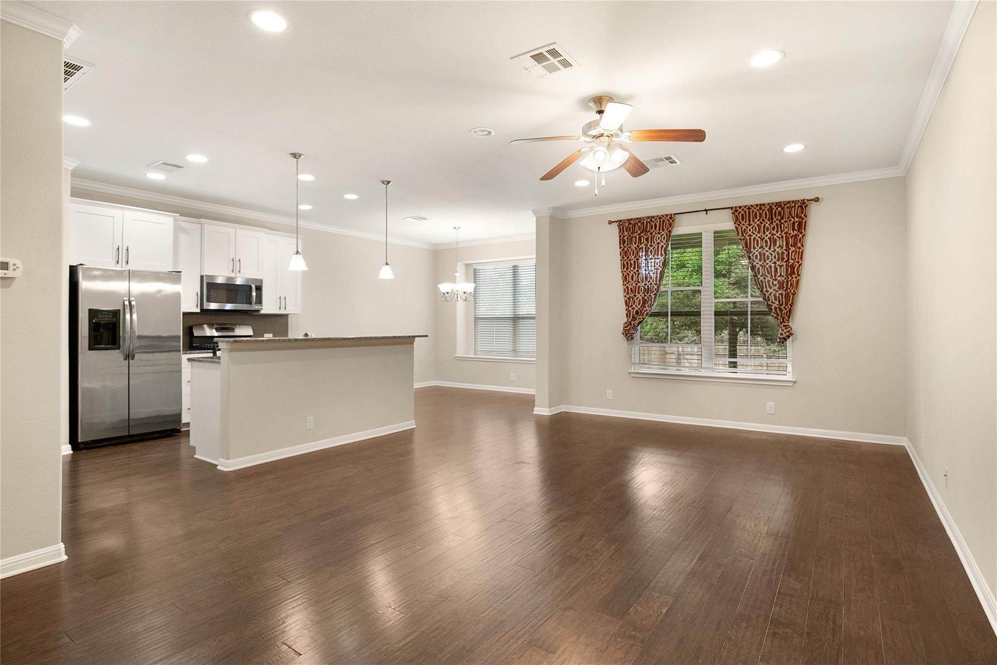 Rich hardwood flooring anchors the spacious open 