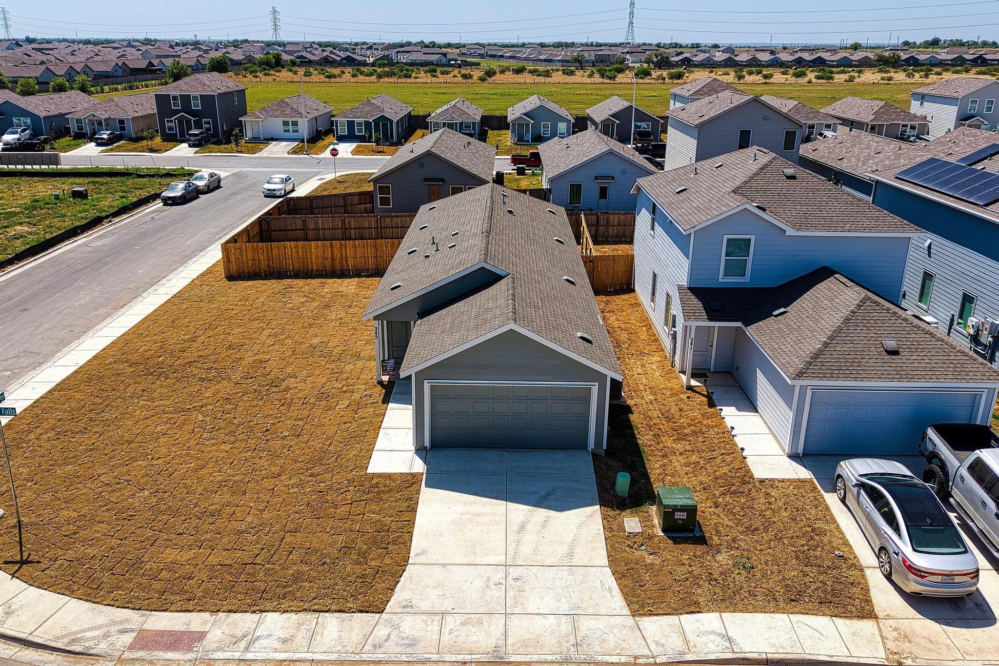 Shingle roofs and concrete driveways anchor this 