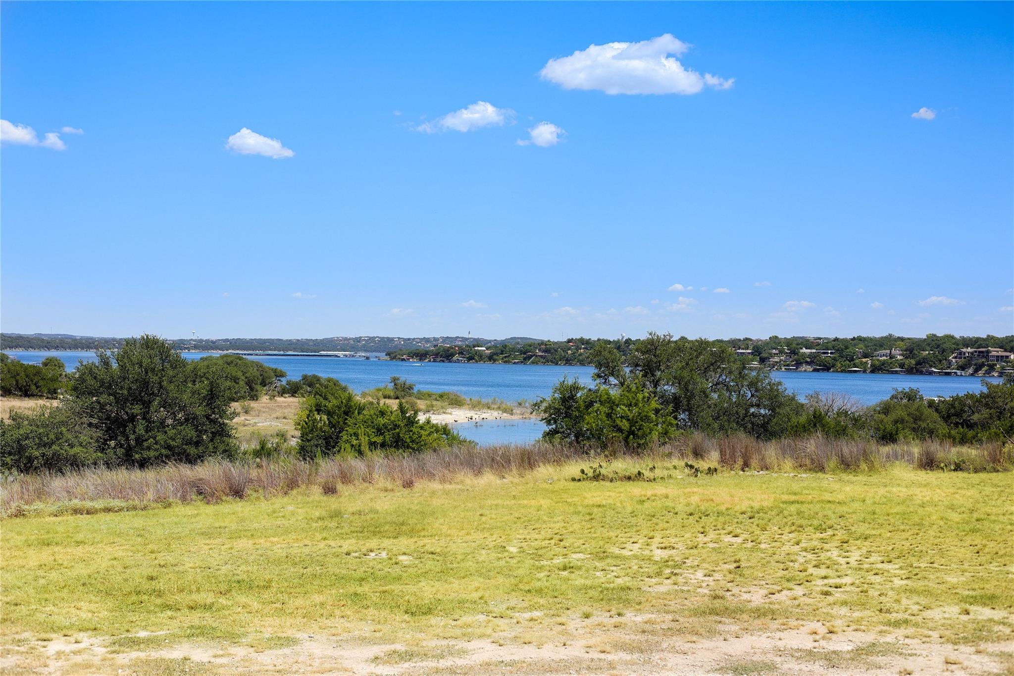 Rolling grassy fields open up to expansive waterf