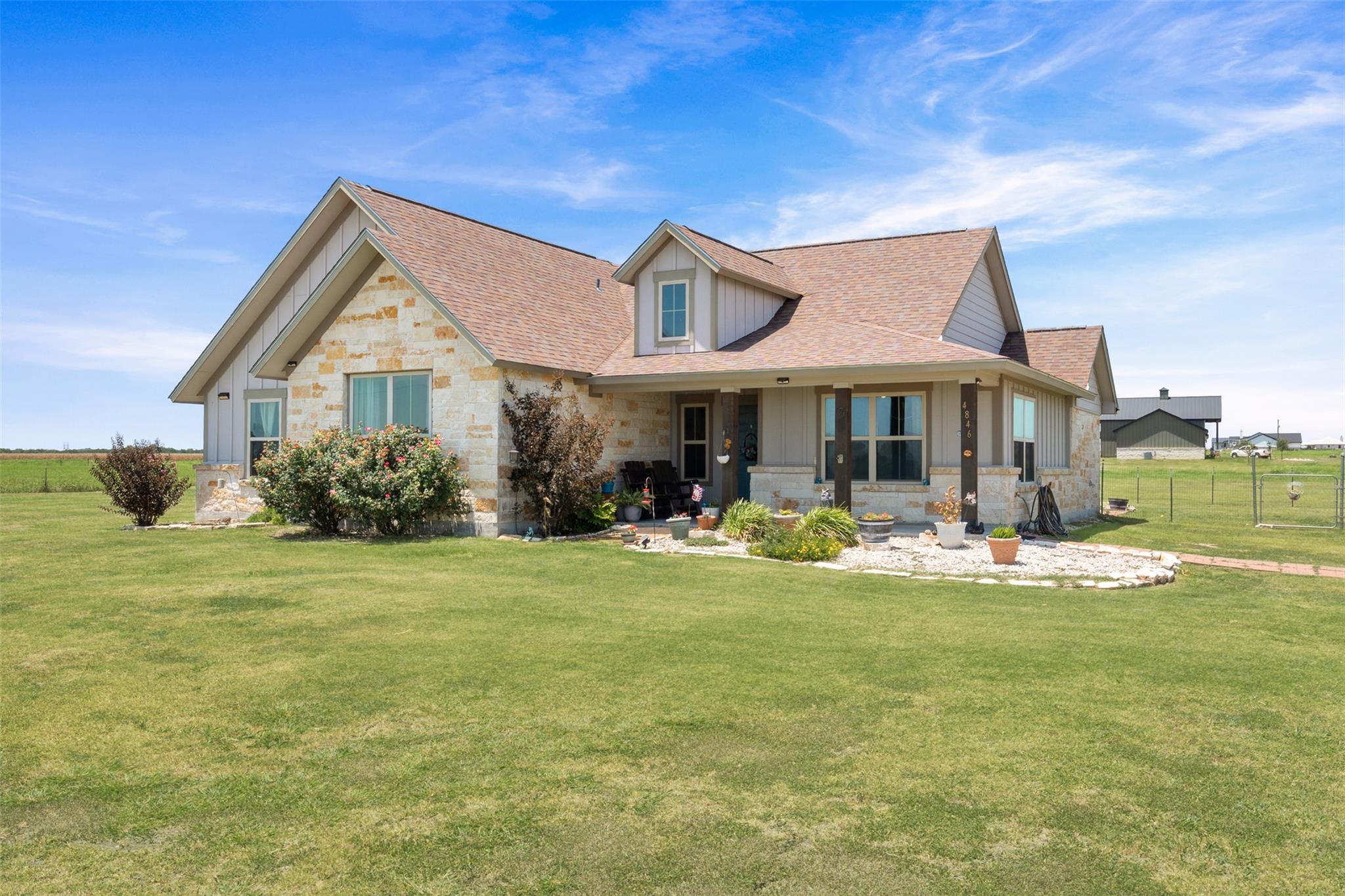 An expansive green lawn welcomes you to this mode
