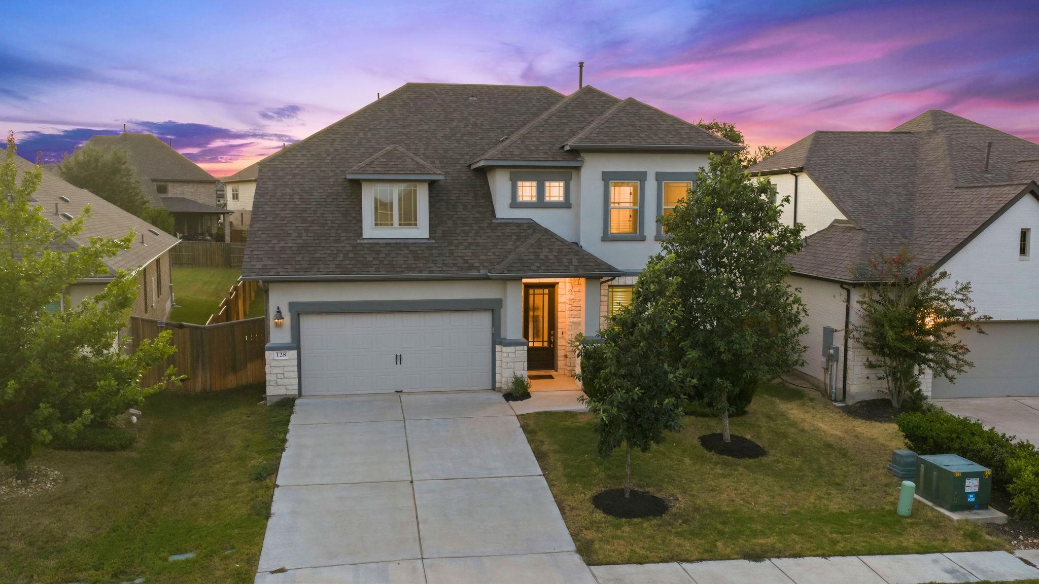 An inviting stone and stucco exterior sits behind