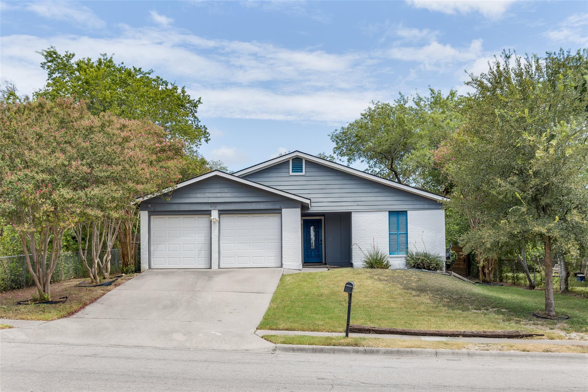 A classic ranch exterior pairs siding and brick a