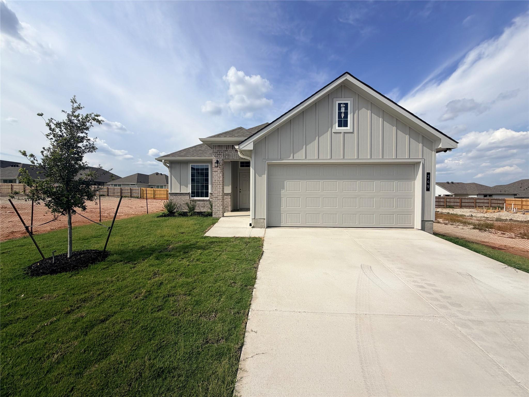 A wide concrete driveway leads to the integrated 