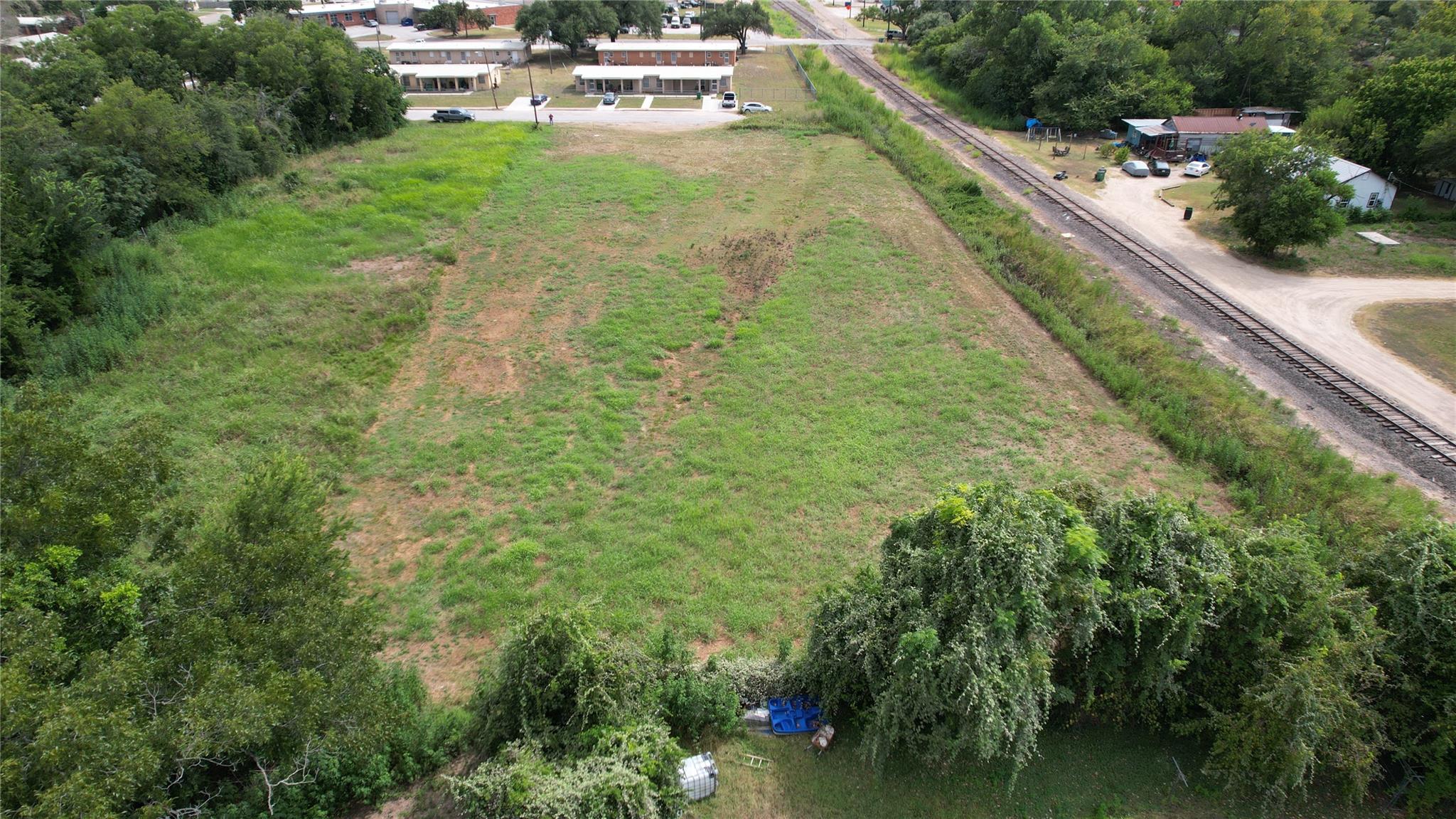 An aerial perspective showcases a spacious grassy