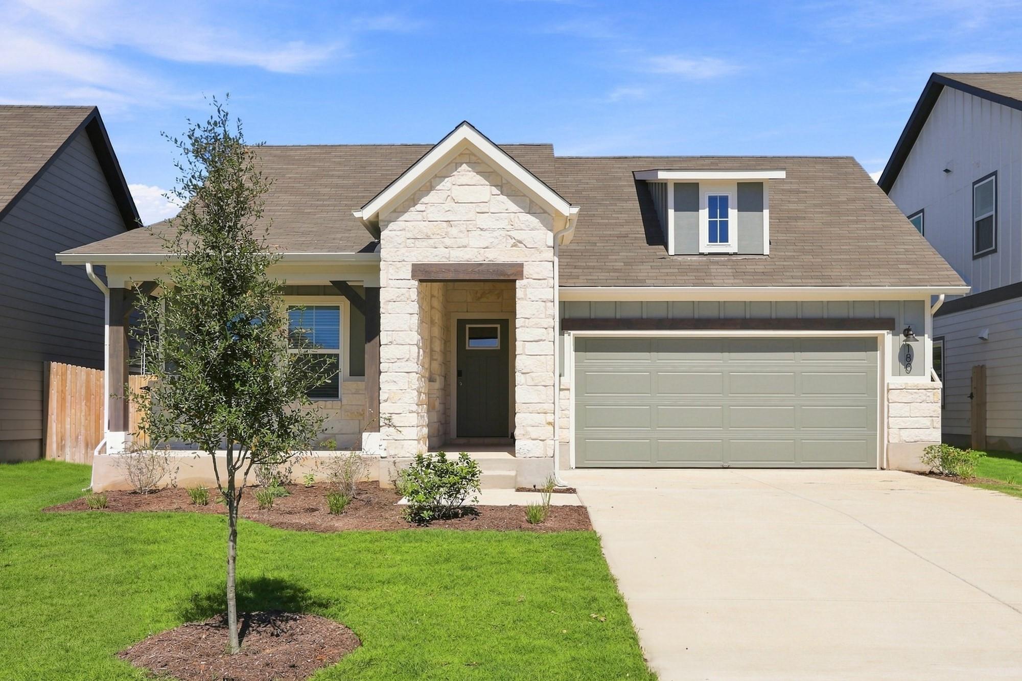 Crisp stone accents and a manicured lawn define t