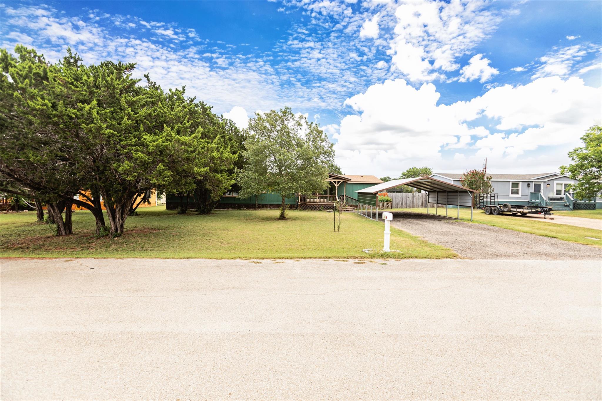 Mature trees shade the spacious front yard featur