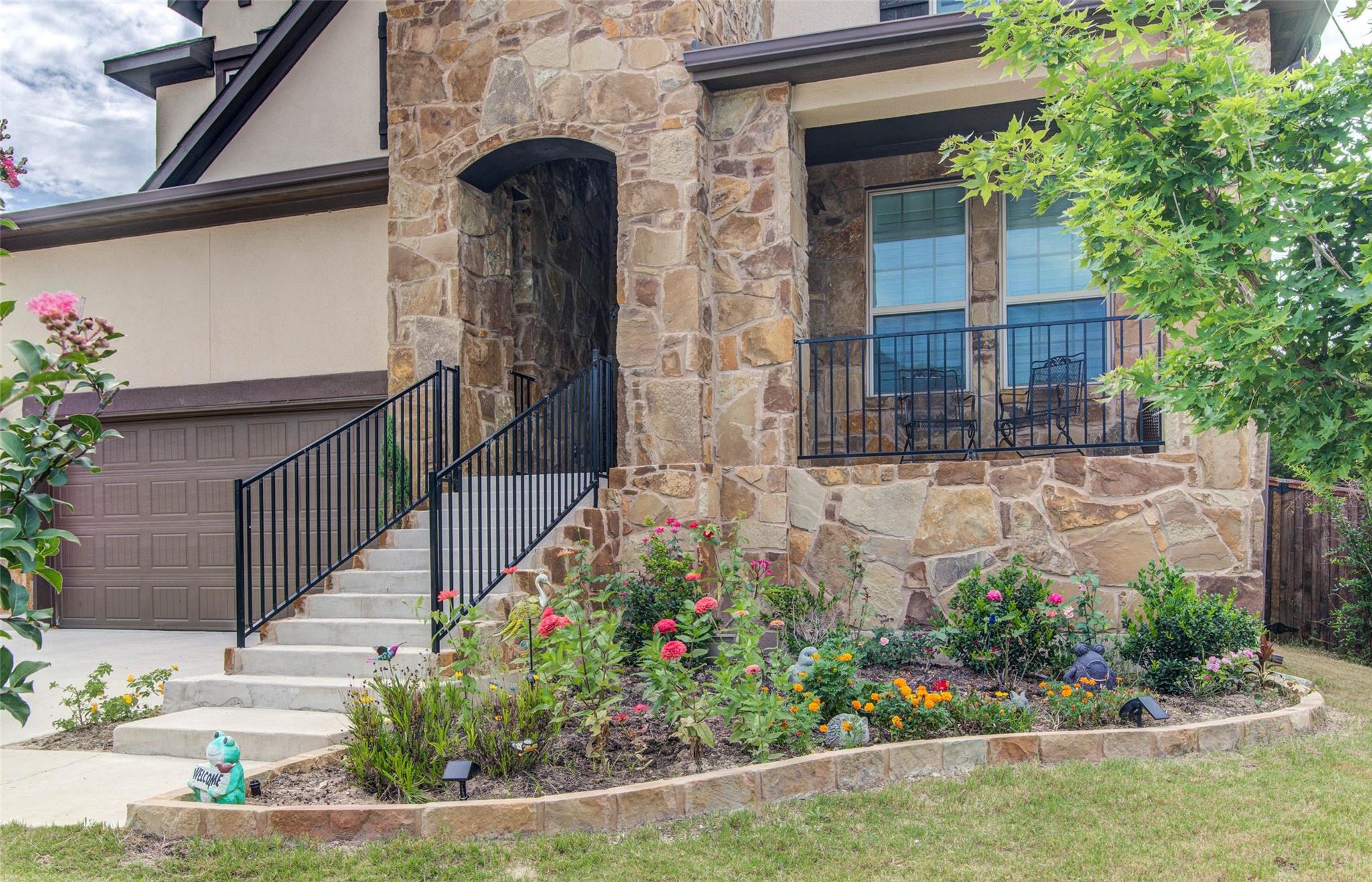 Natural stone masonry frames the grand arched ent