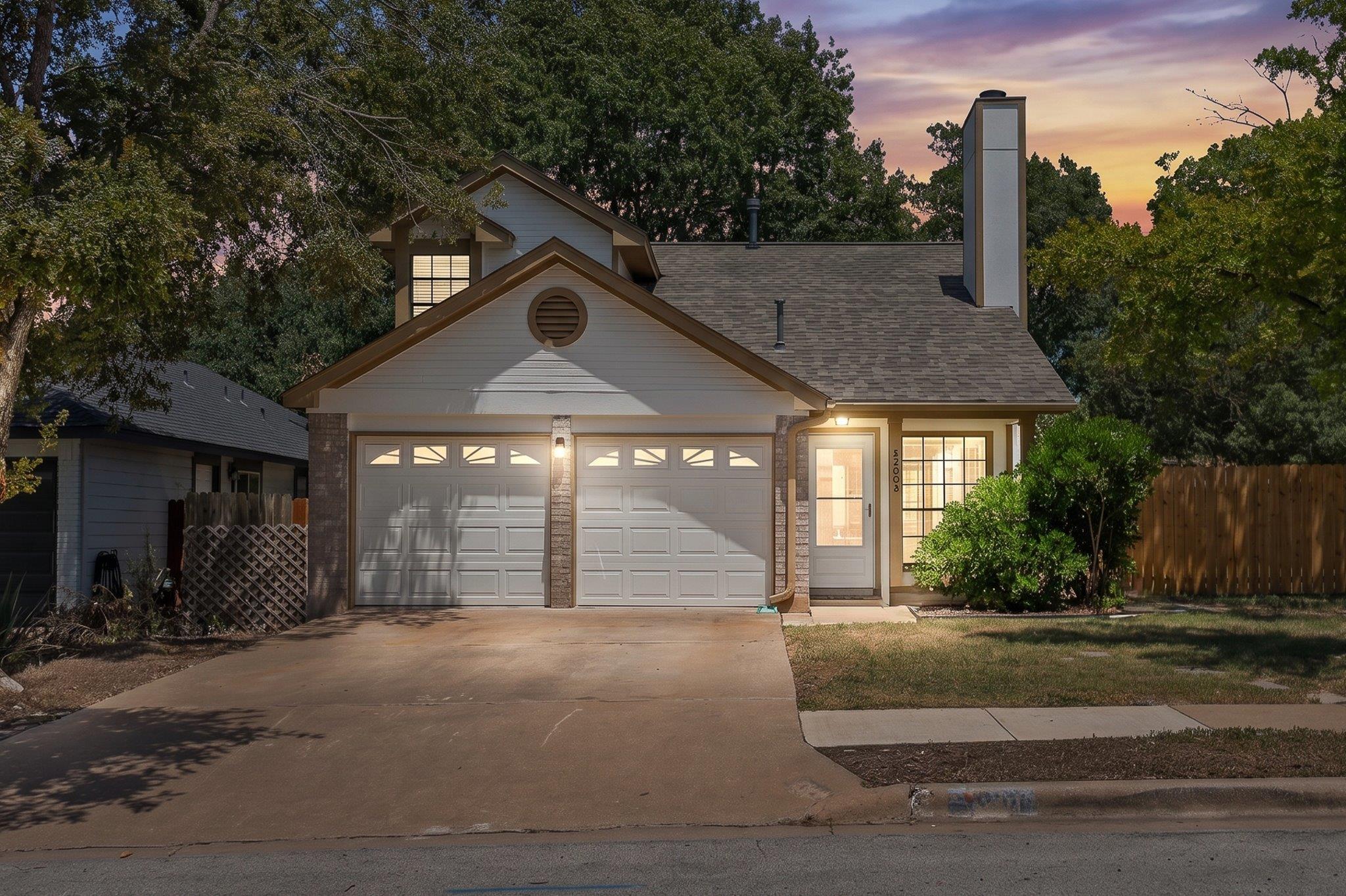 Mature trees frame a classic two-story exterior c