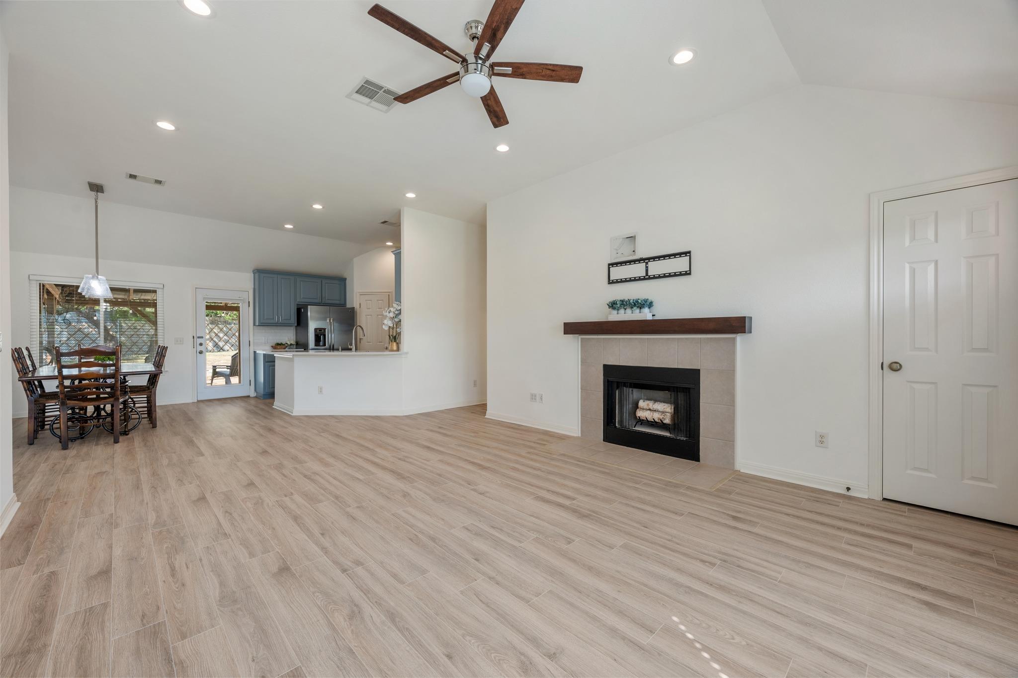 Gleaming wood-look floors complement a cozy firep
