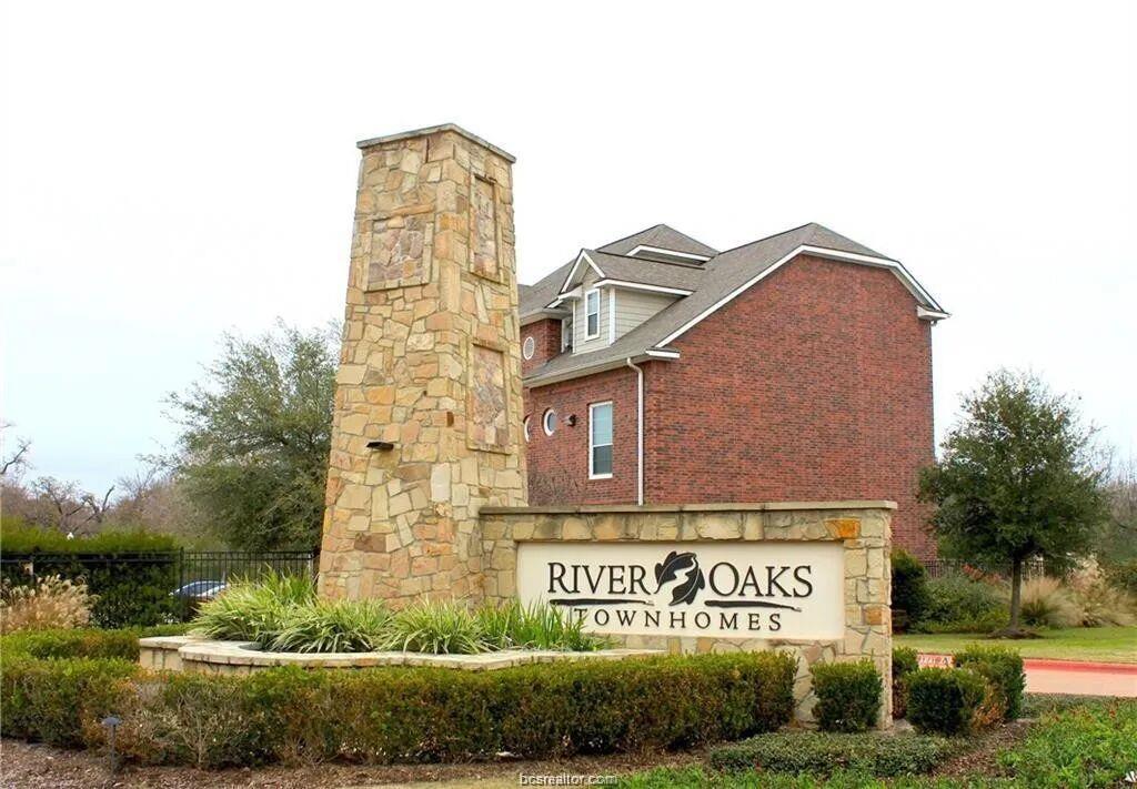 An inviting stone-accented community sign stands 
