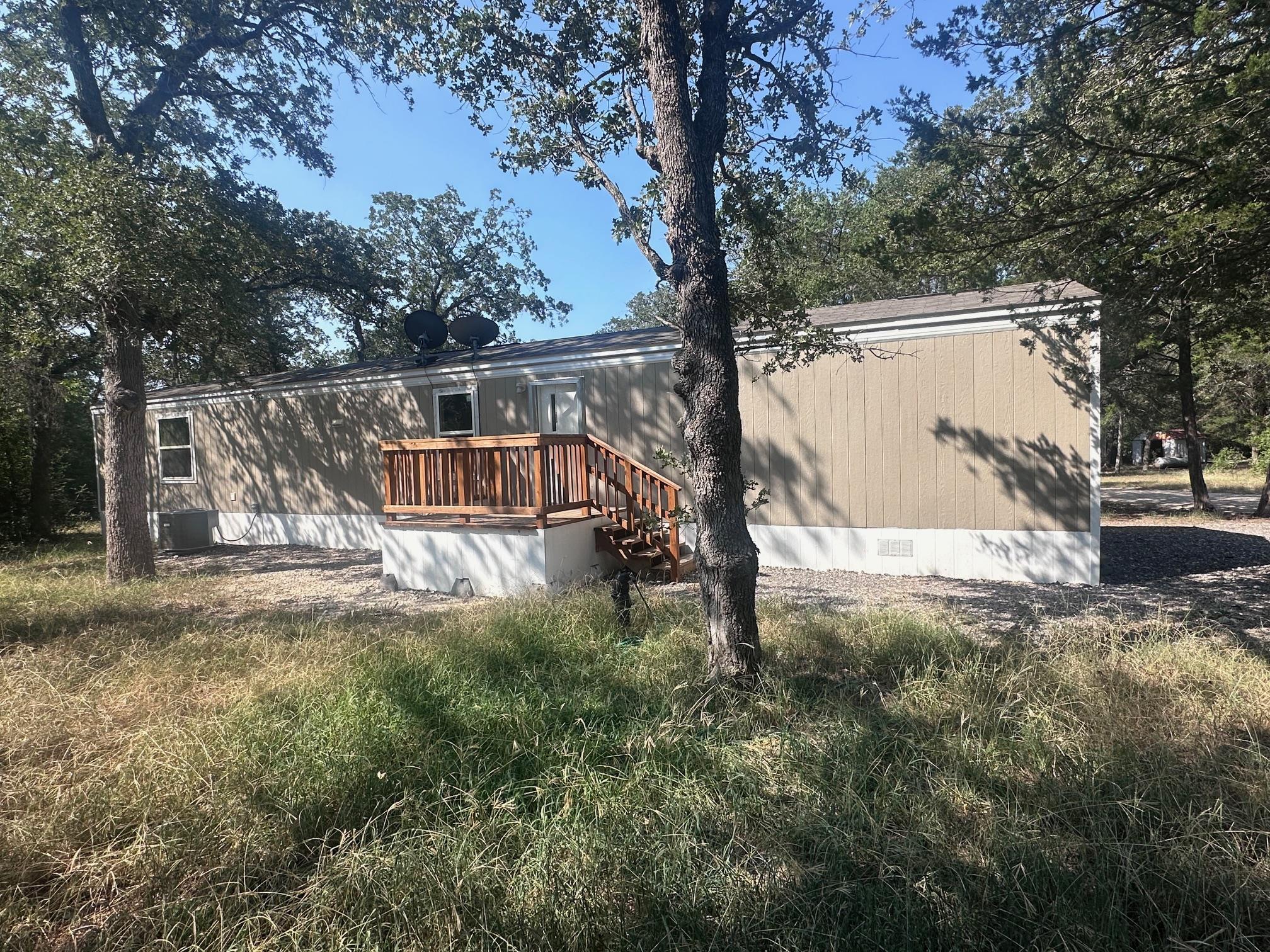 Mature trees shade a quiet property featuring a r