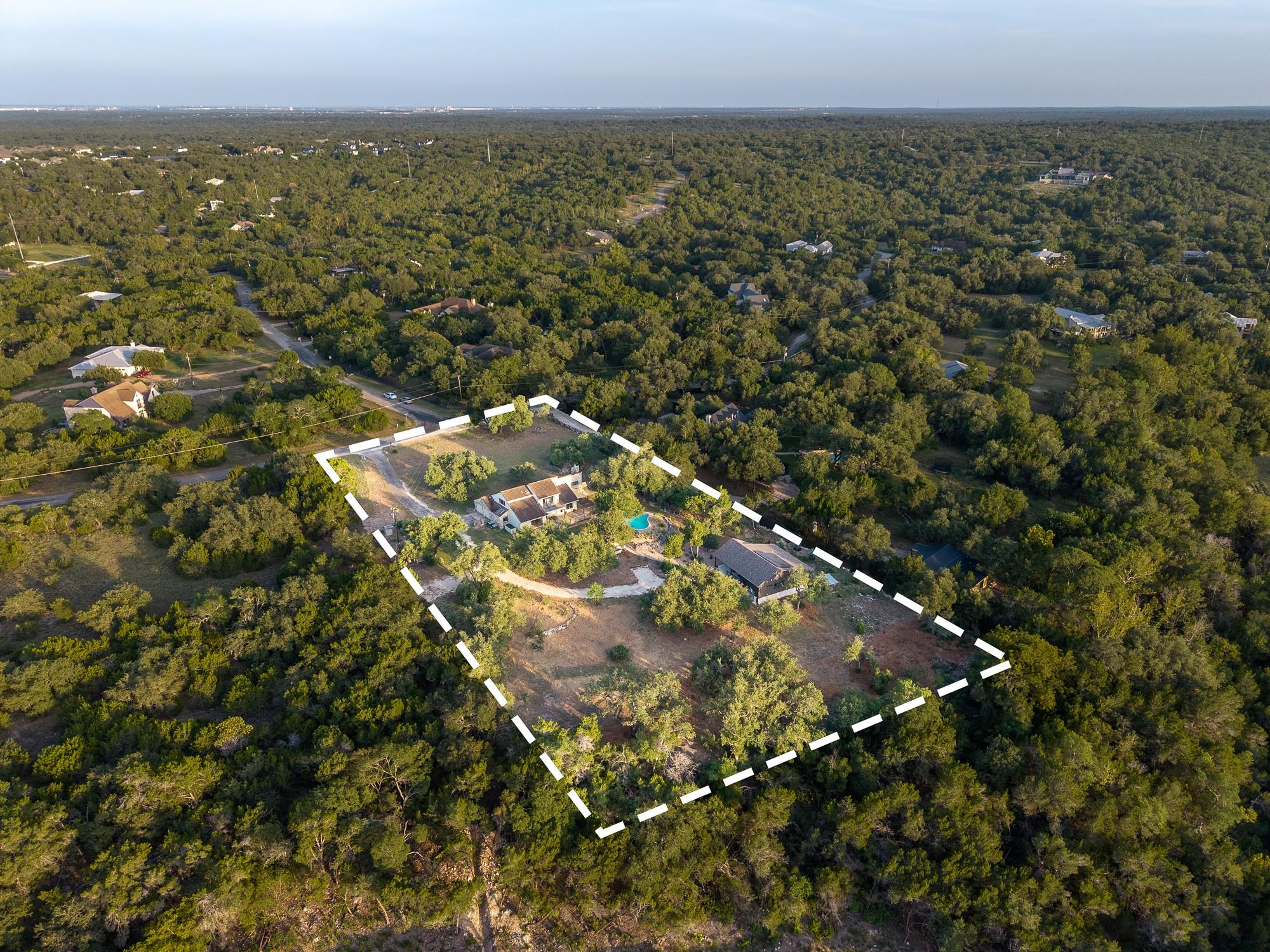 A sprawling wooded acreage highlights this privat