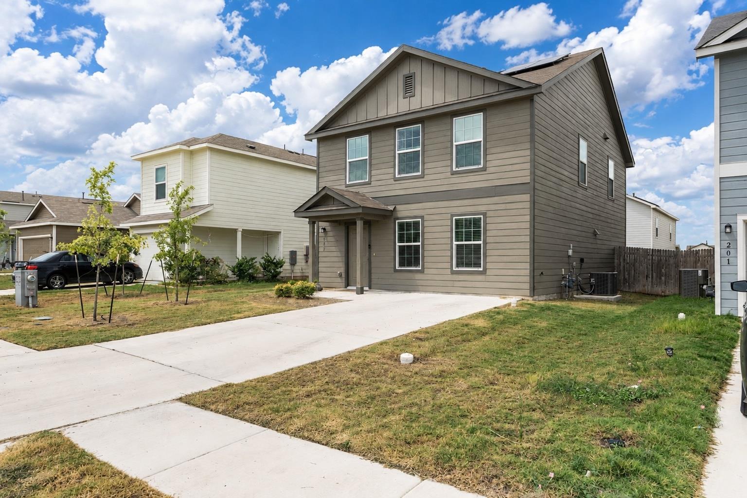 A concrete driveway leads to this two-story home 