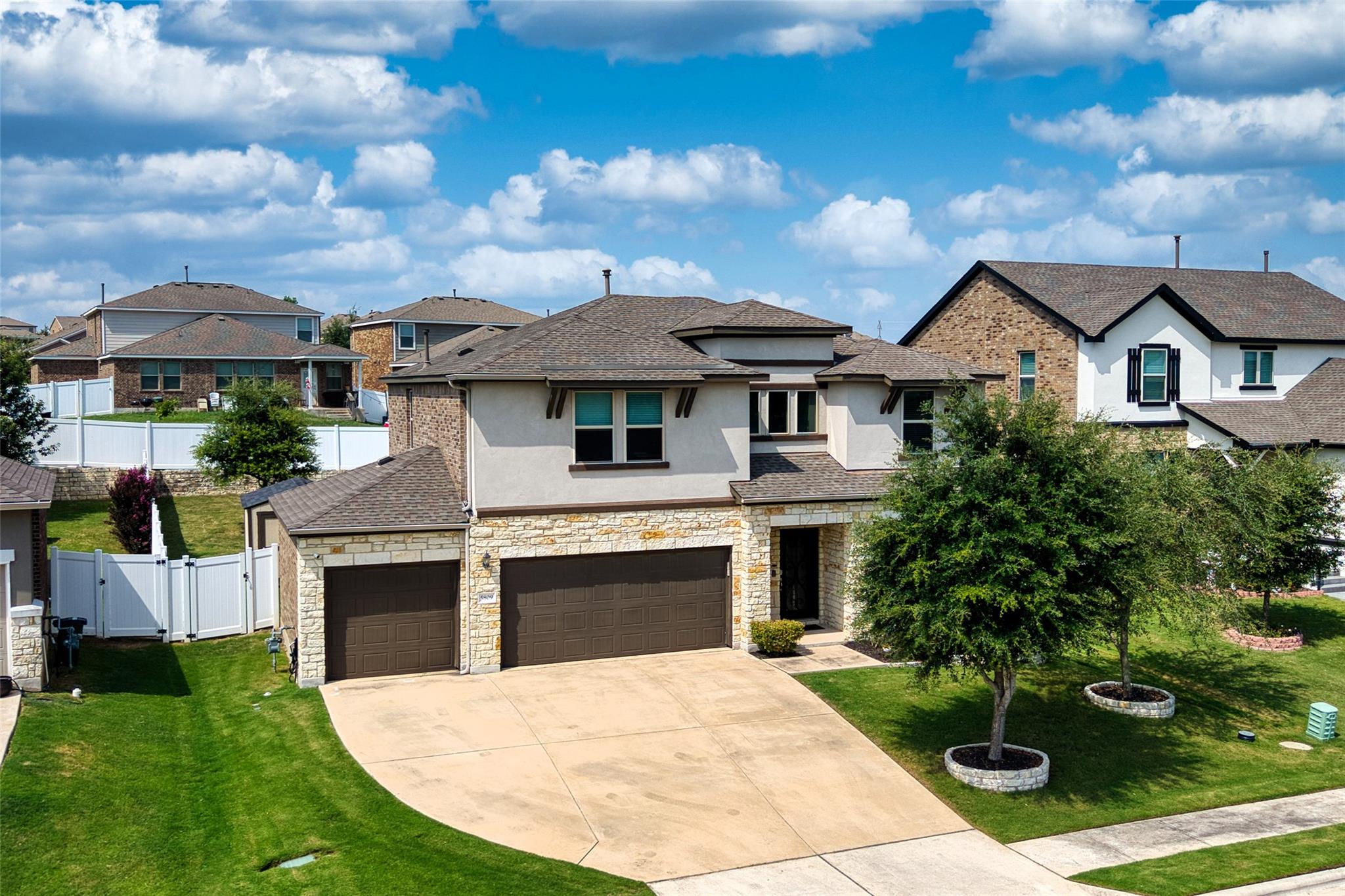A stone-accented facade paired with a spacious dr