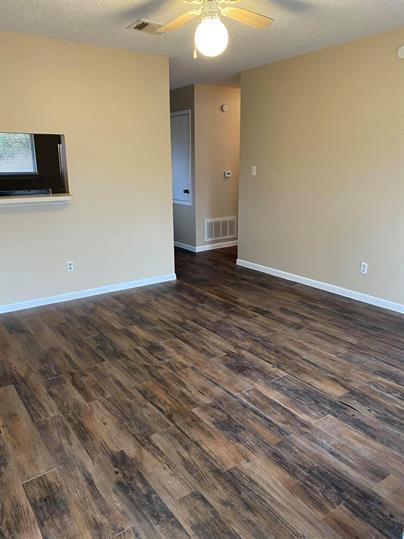 Rich wood-look flooring anchors this open living 