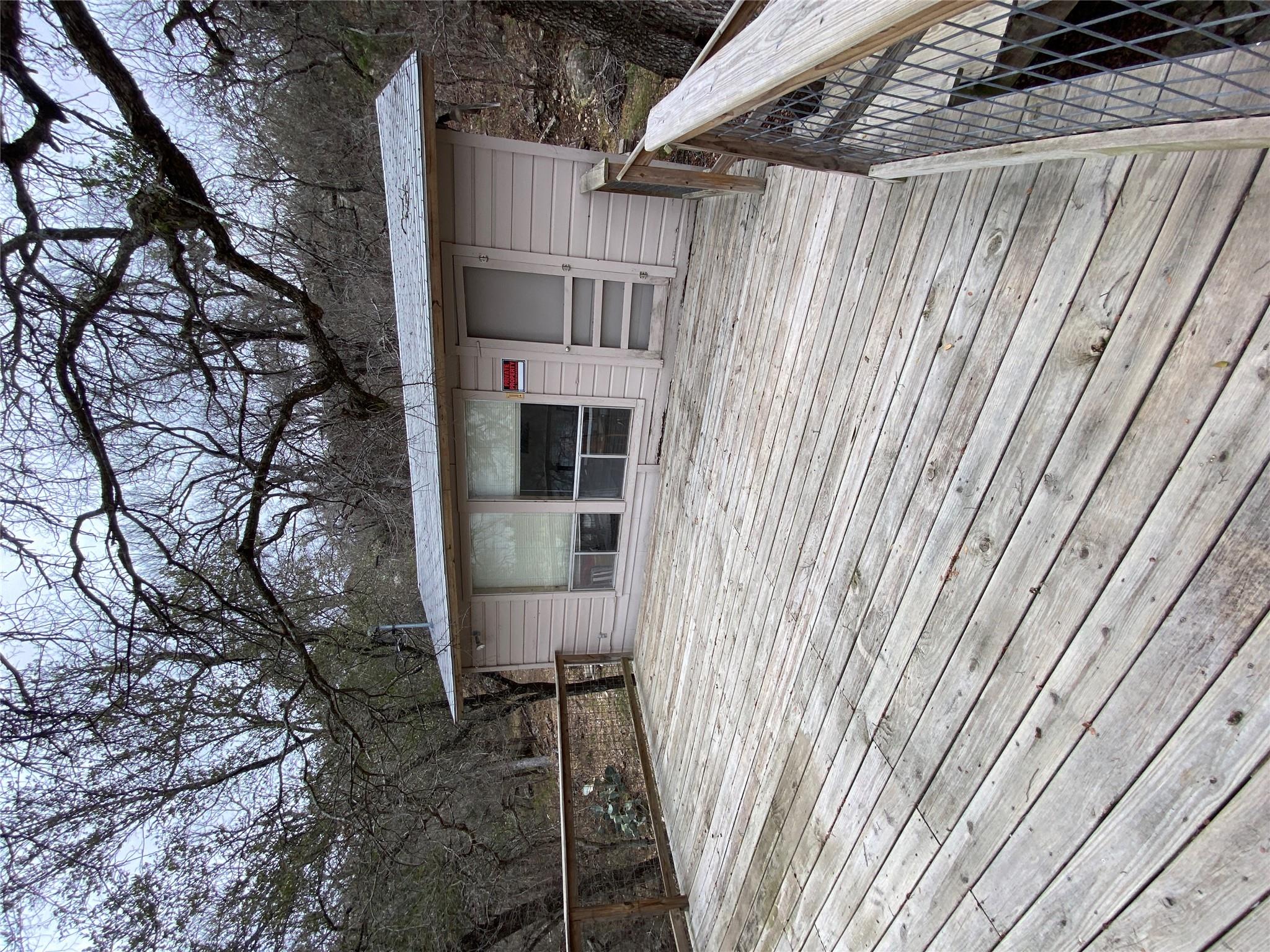 A spacious wooden deck connects directly to a cha