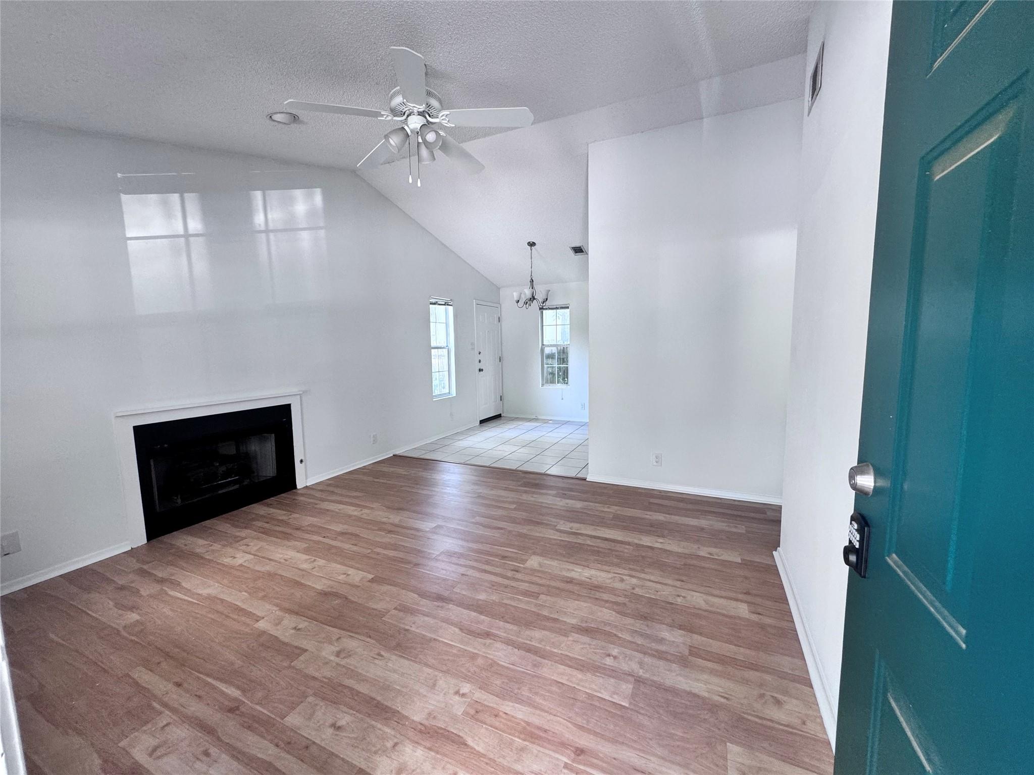 Soaring vaulted ceilings and rich wood floors fra