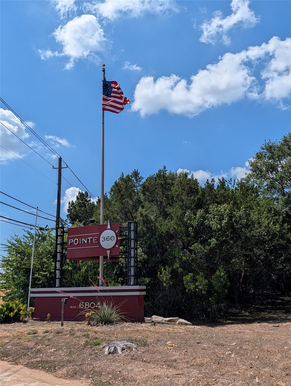 An established neighborhood entrance marked by pr