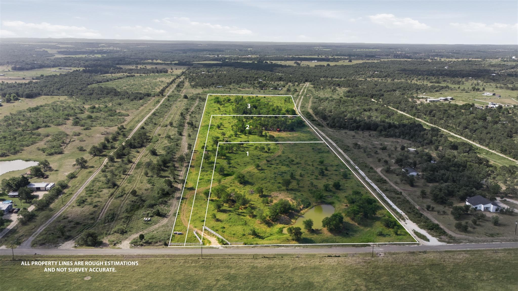 Expansive green acreage unfolds under a vast sky,