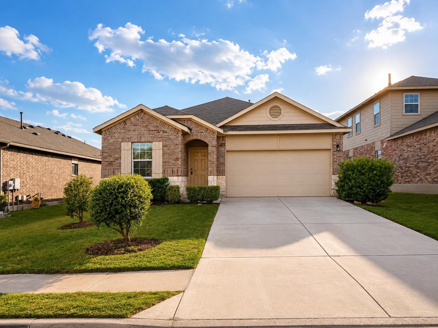 A classic brick exterior and a concrete driveway 