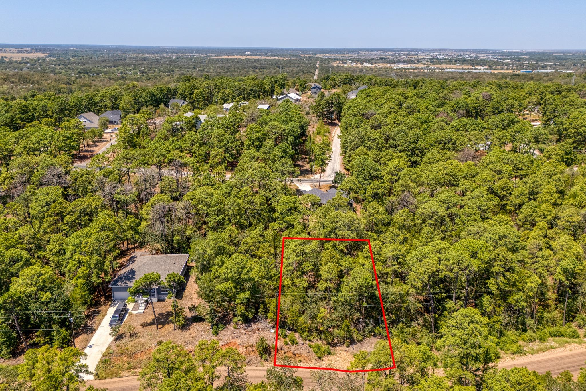 Mature trees blanket this elevated lot situated w