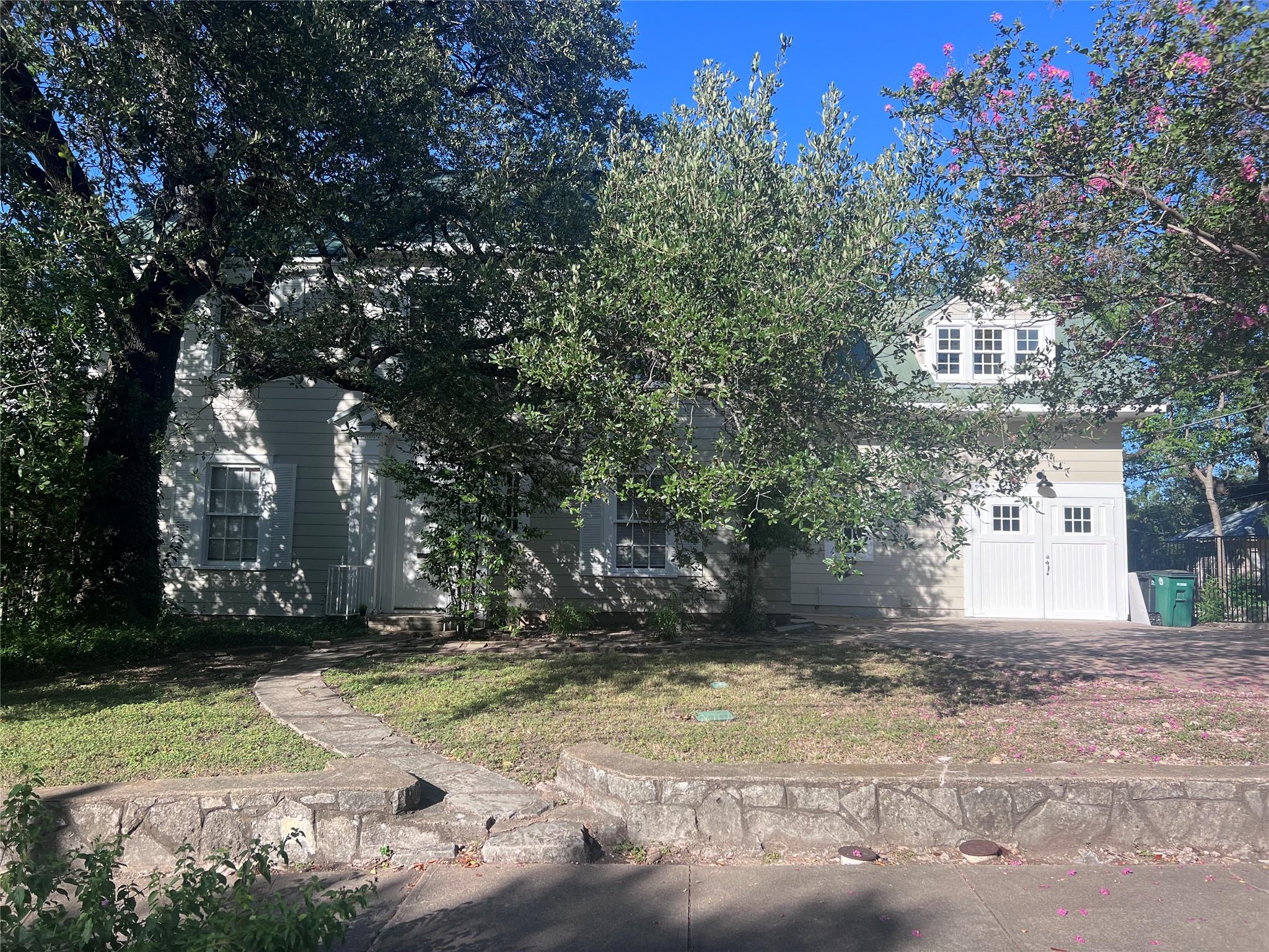 Mature trees shade a classic multi-story exterior