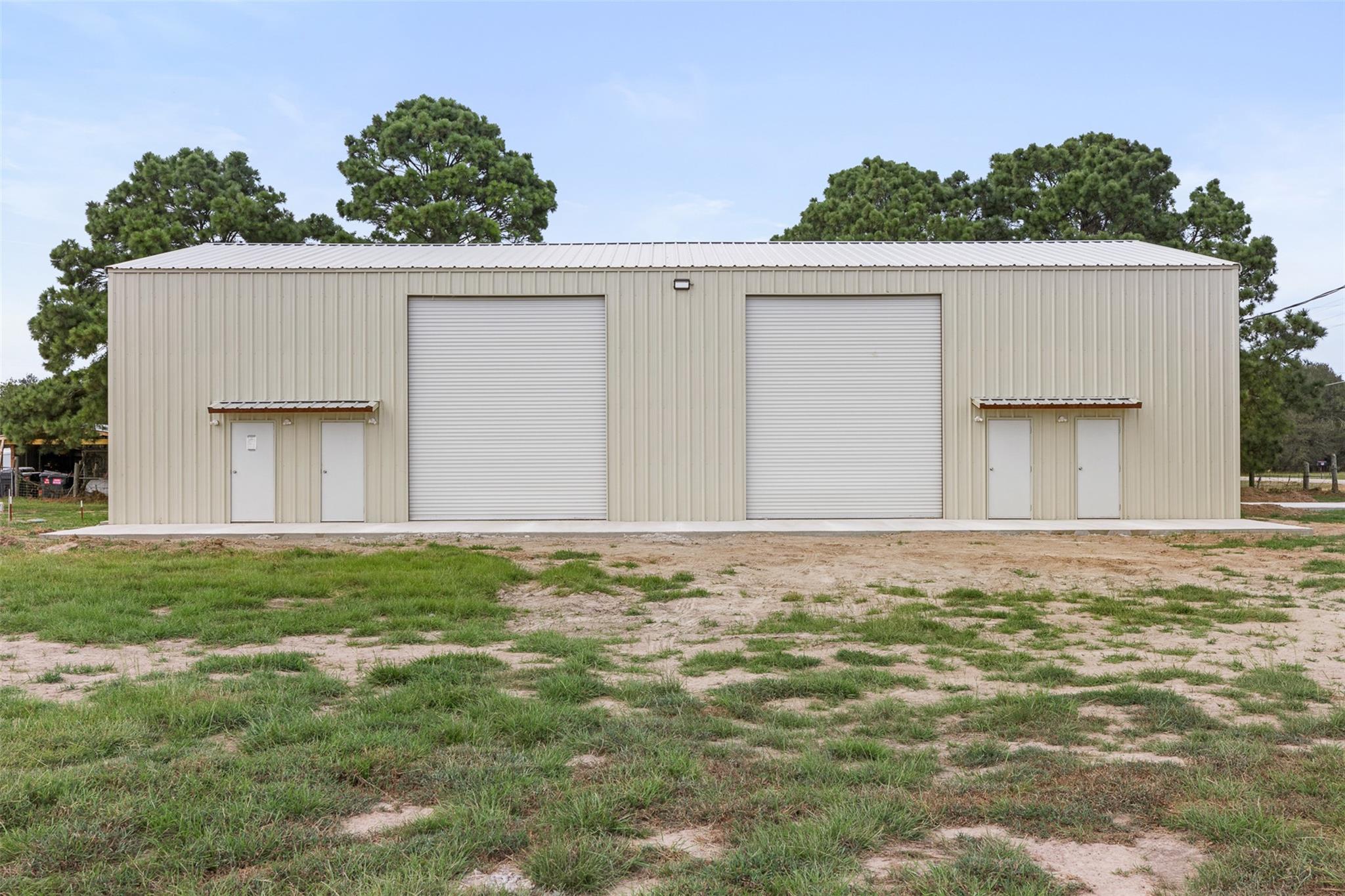 An expansive metal outbuilding features double ro