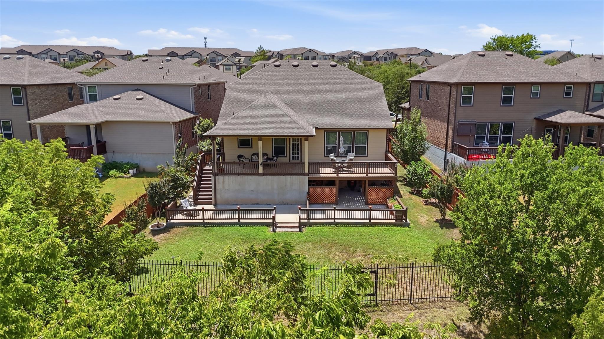 An elevated back deck overlooks a spacious, fence