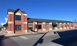 A prominent brick exterior presents classic archi