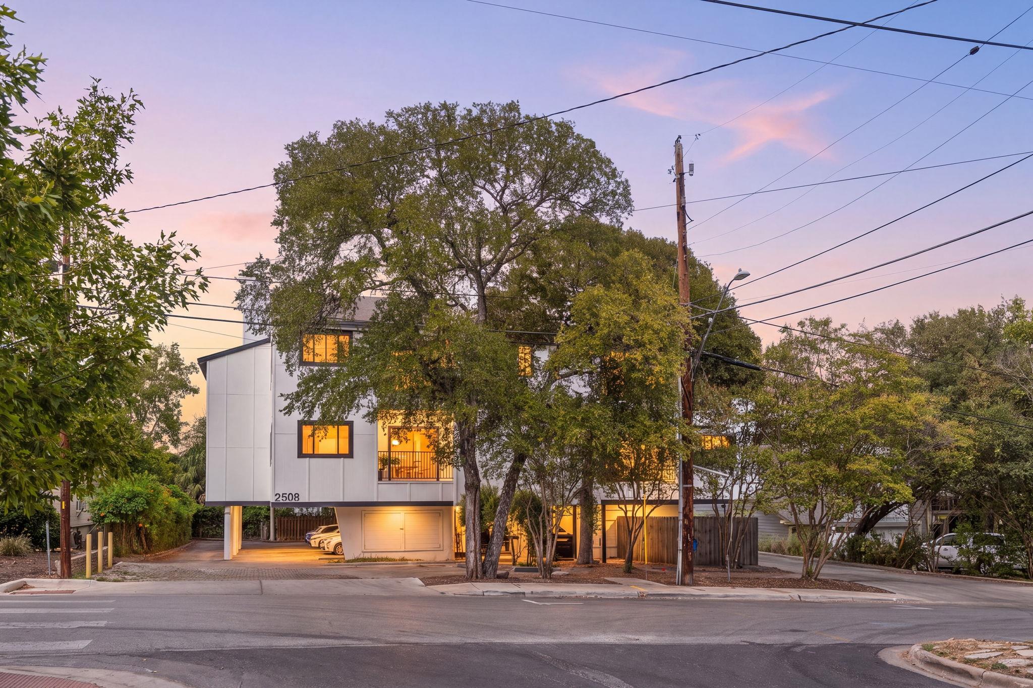 Mature trees frame a modern multi-level exterior 