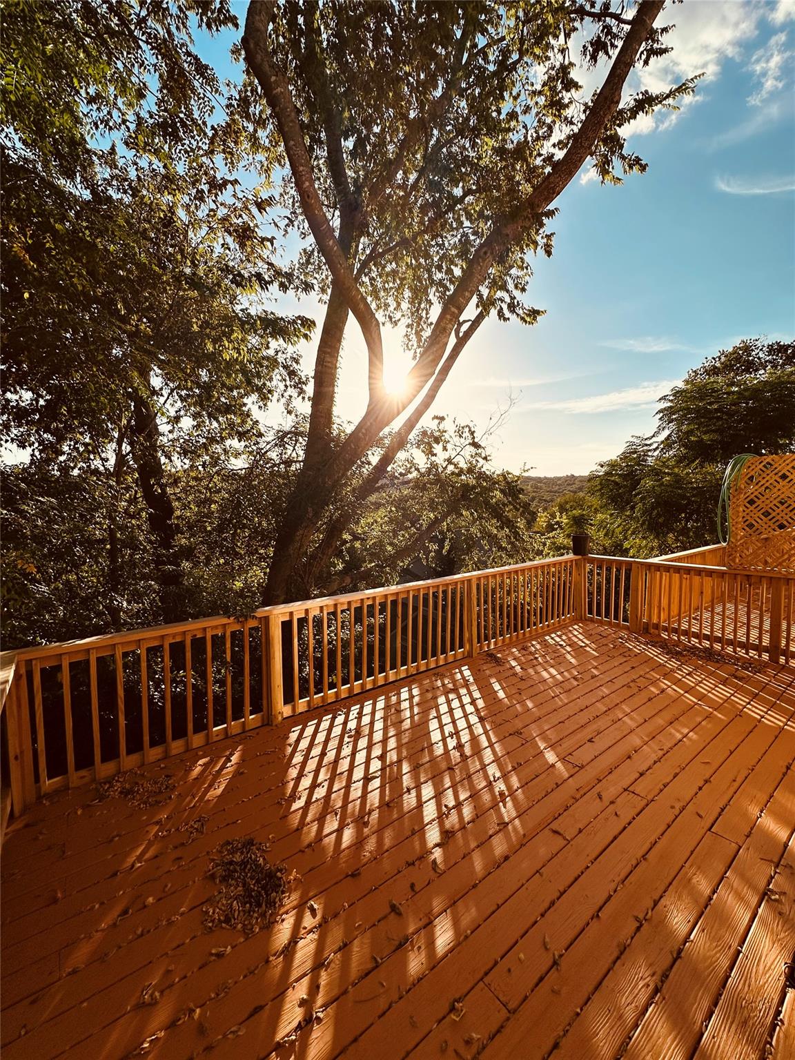Mature trees frame the sweeping views from this e