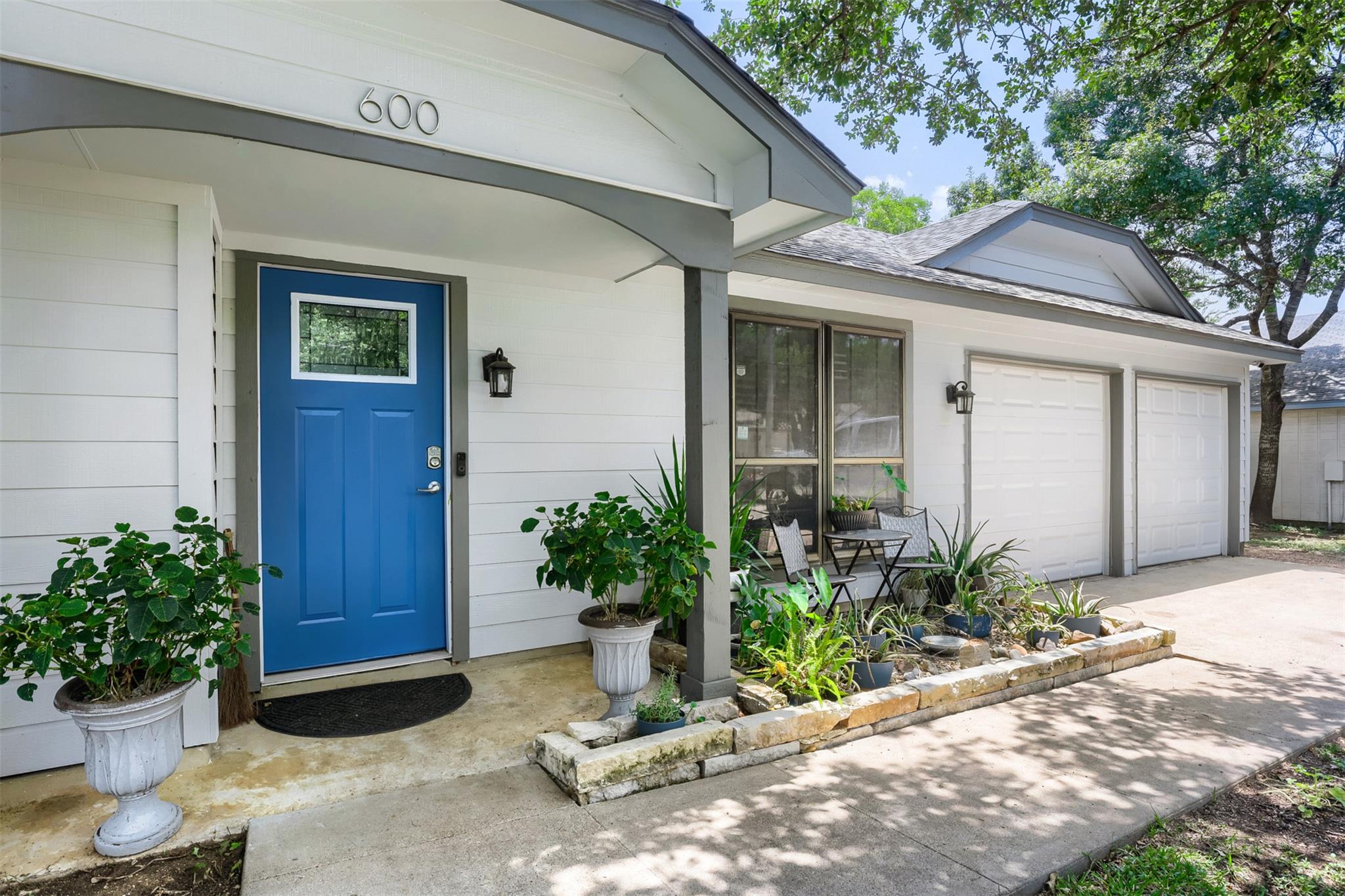 A welcoming front entry features horizontal sidin
