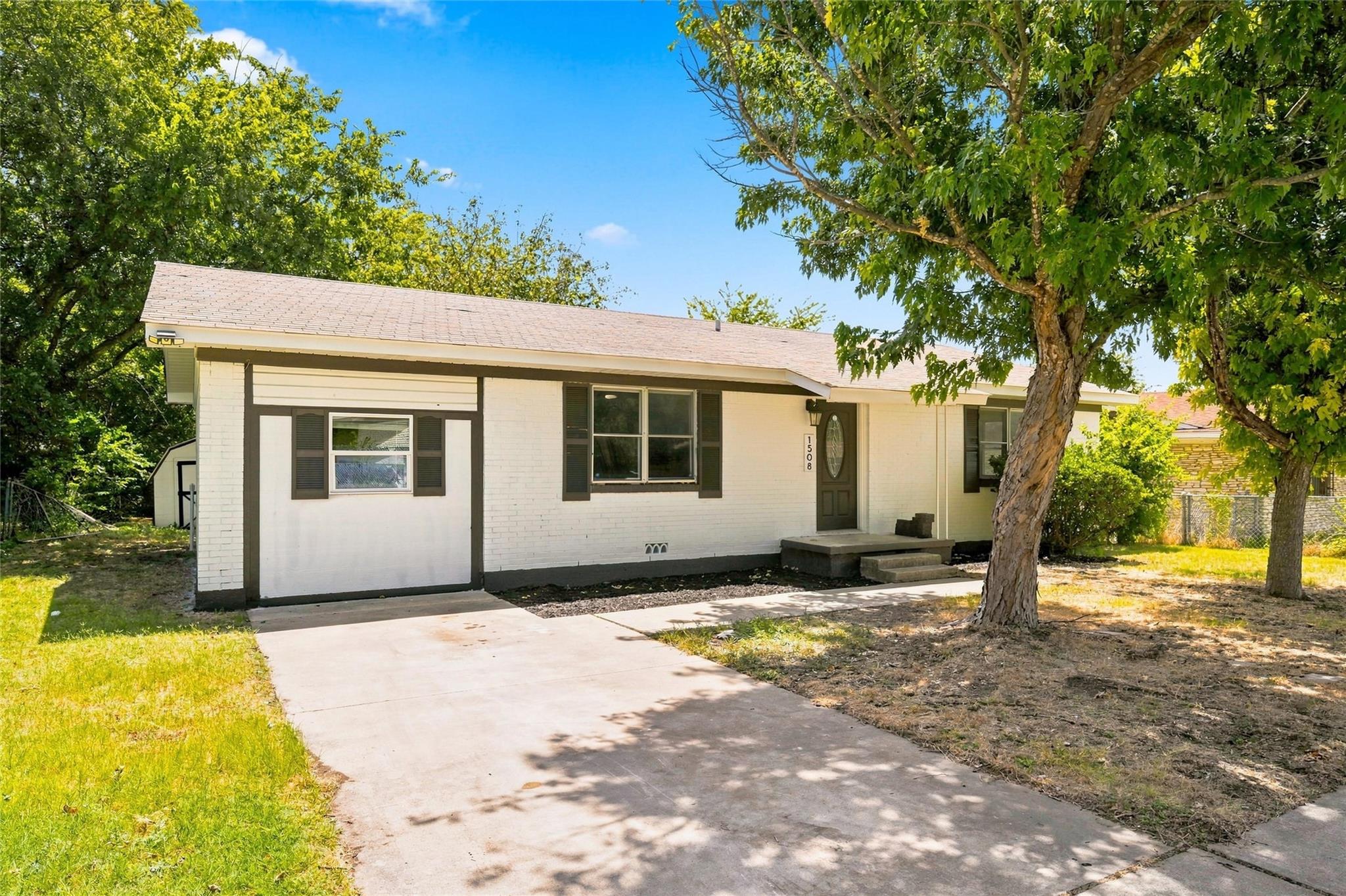 Mature trees shade the front lawn of this classic