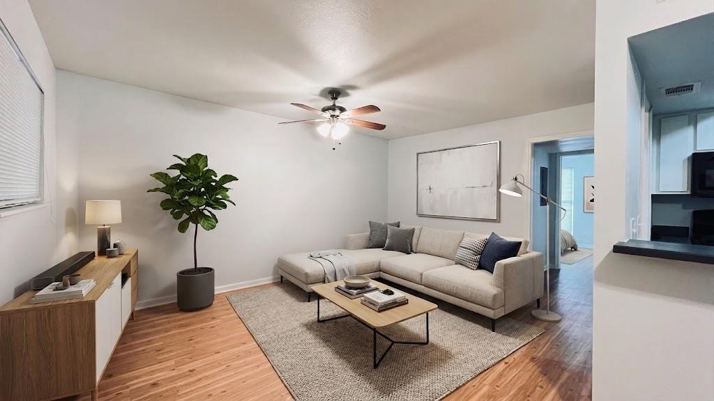 Warm wood-style flooring anchors this comfortable
