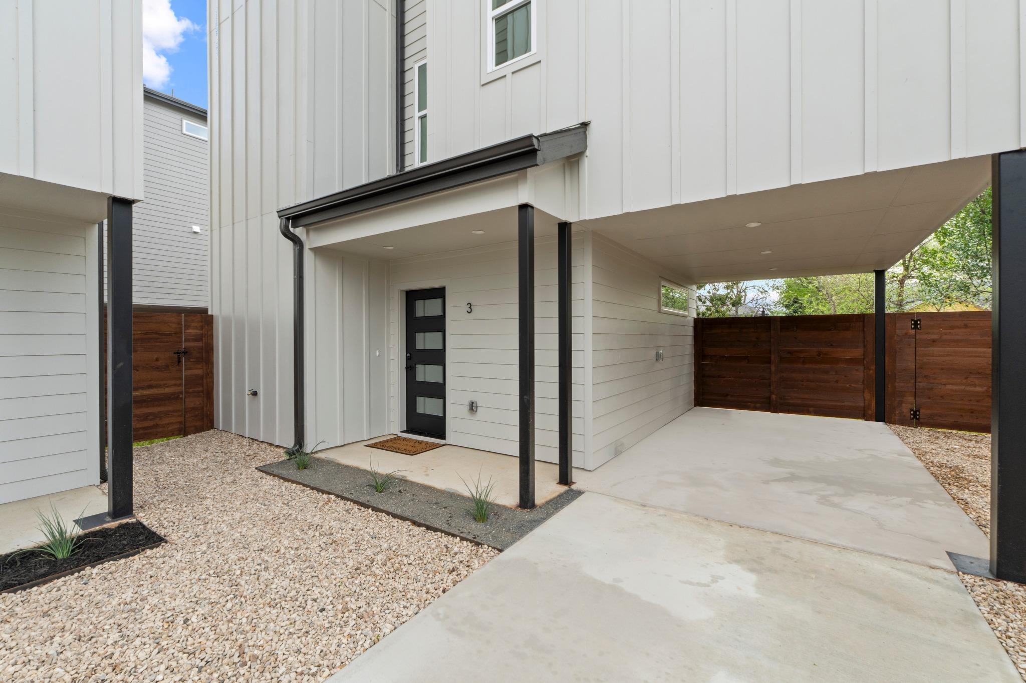Modern vertical siding and a sheltered concrete d