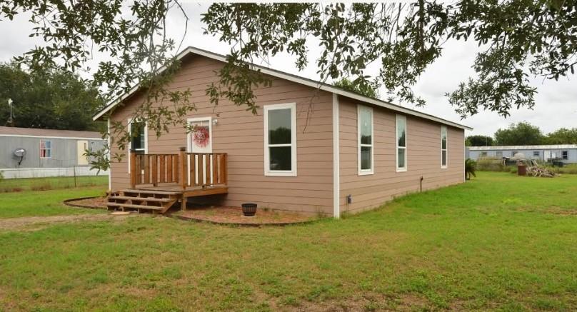 Horizontal siding and a wooden porch define the e
