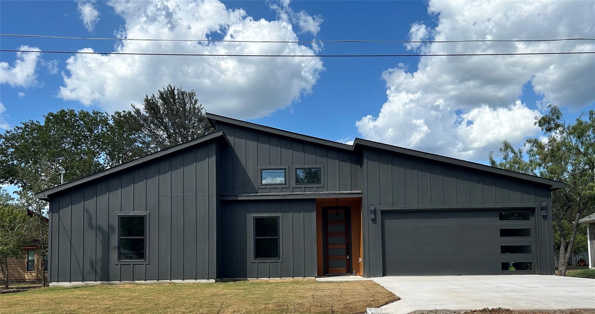 Striking vertical siding and asymmetrical rooflin