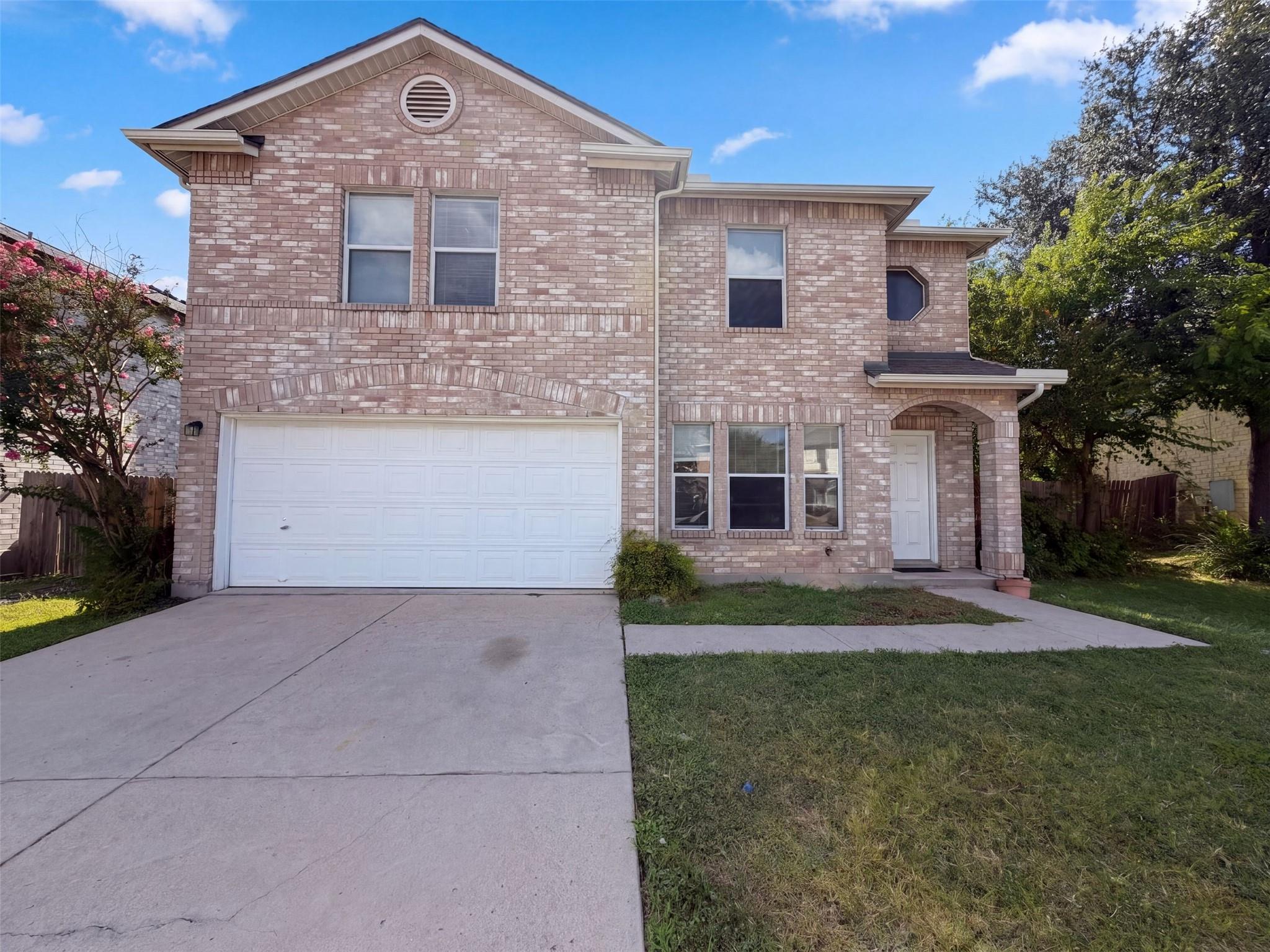 A spacious brick exterior and concrete driveway d