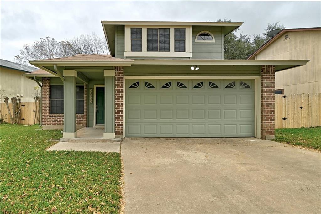 An inviting exterior displays brick accents, a tw