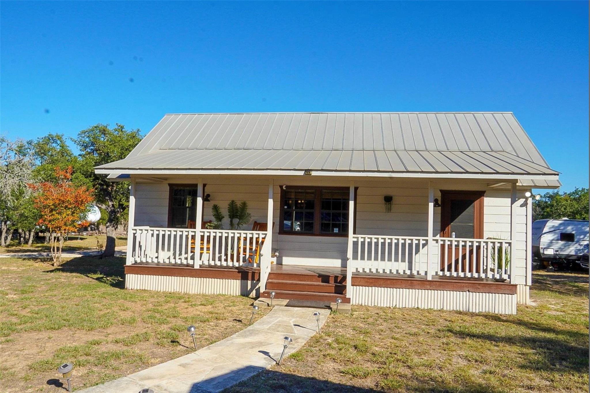 A welcoming front porch with classic wooden raili