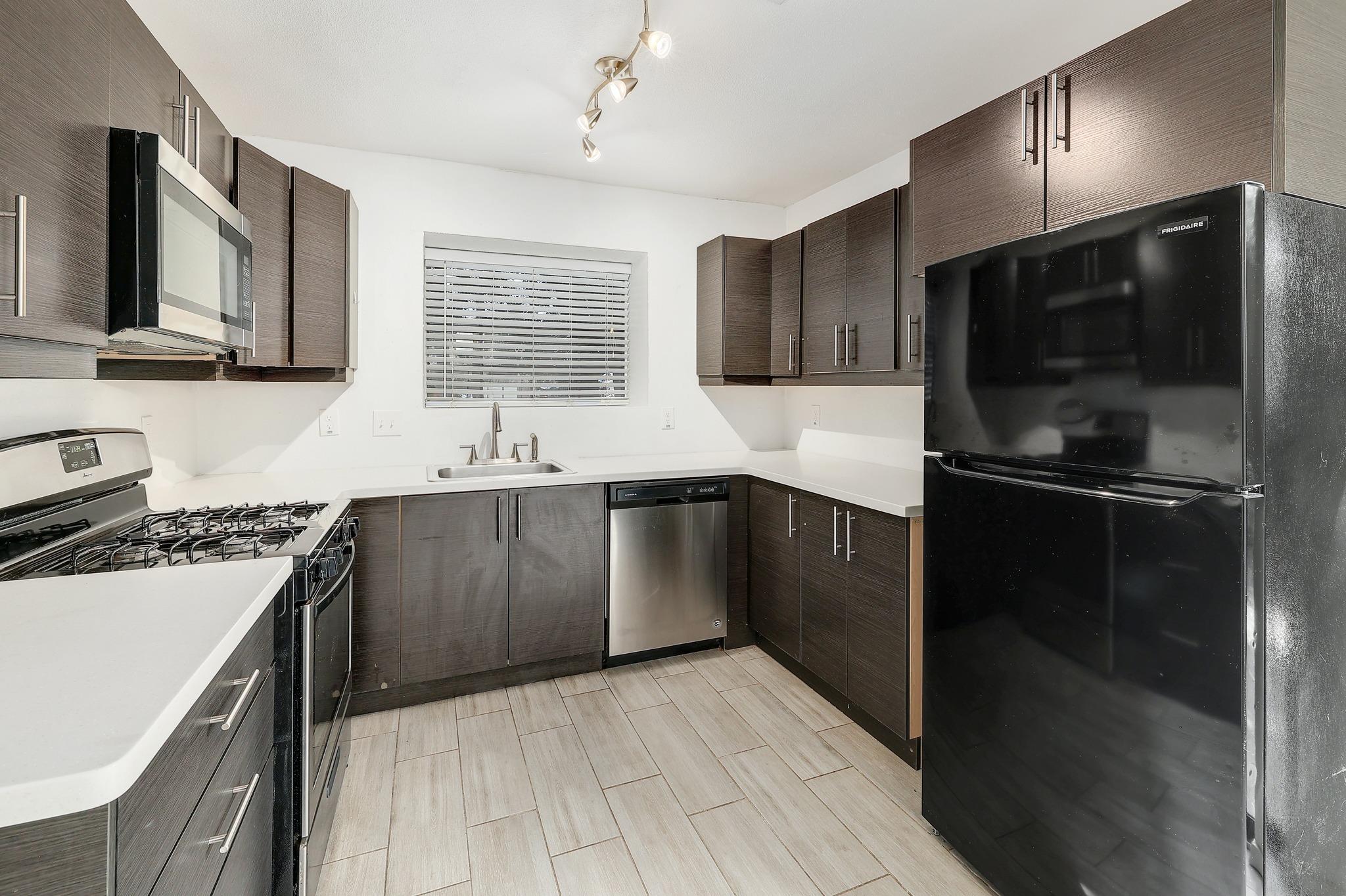 Streamlined cabinetry and modern appliances defin