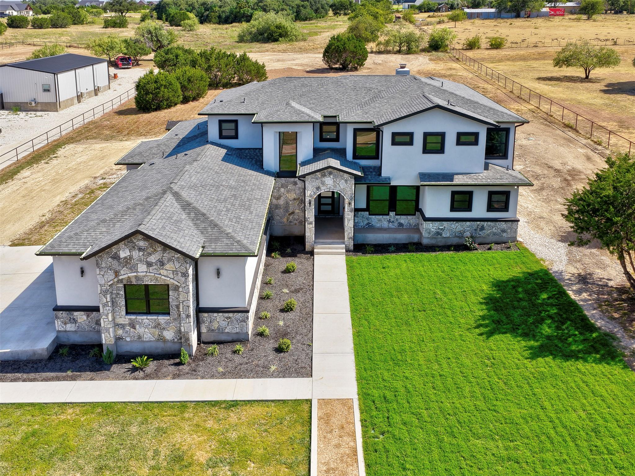 An aerial view showcases the custom stone and stu