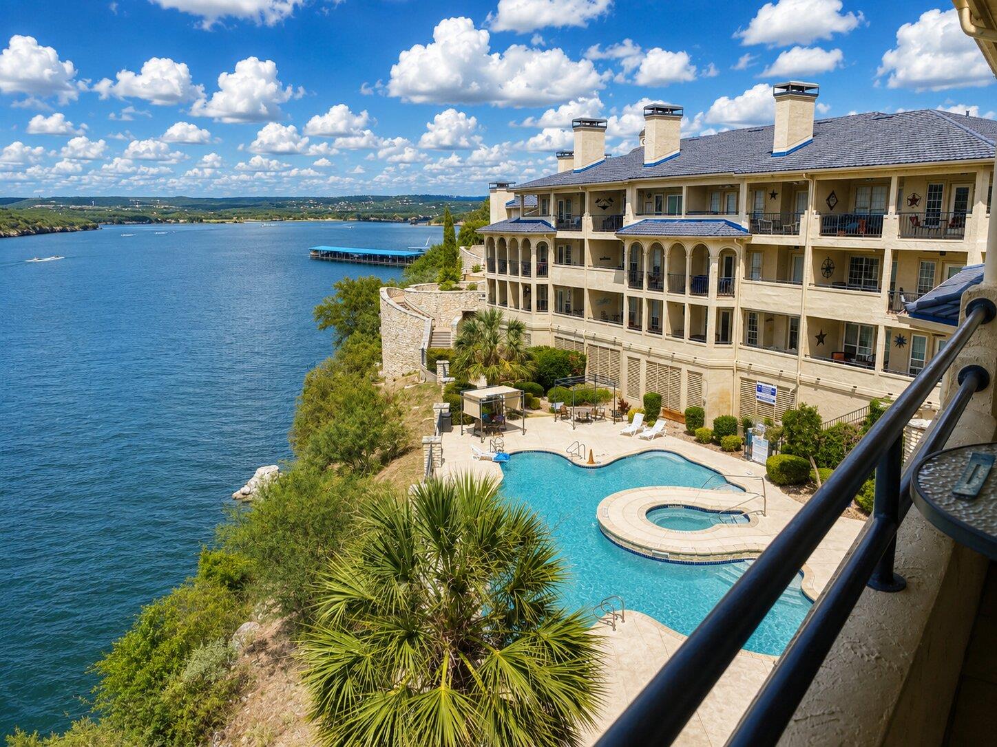 A sparkling lakeside pool and spa sit below the m