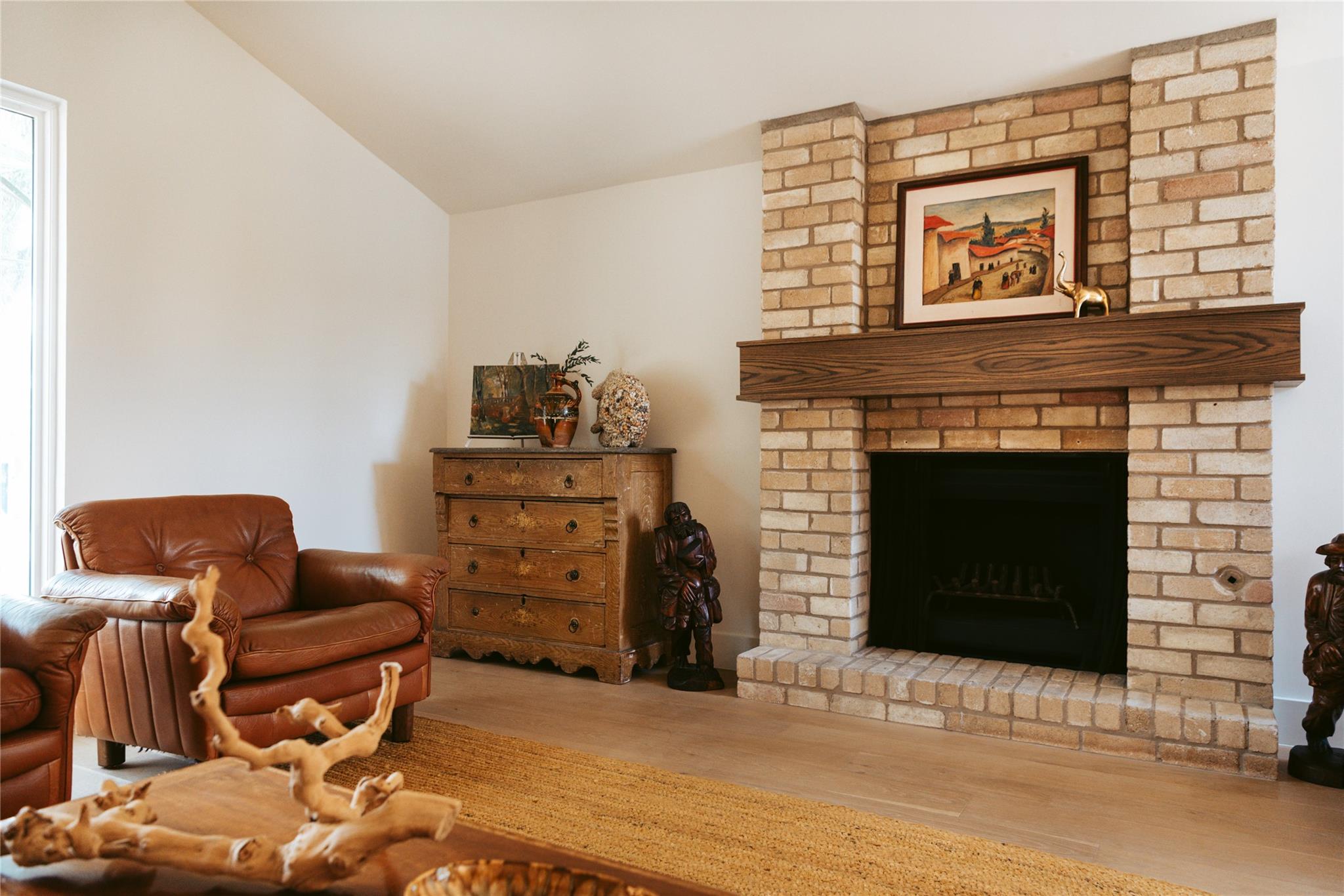Warm hardwood floors complement a classic brick f
